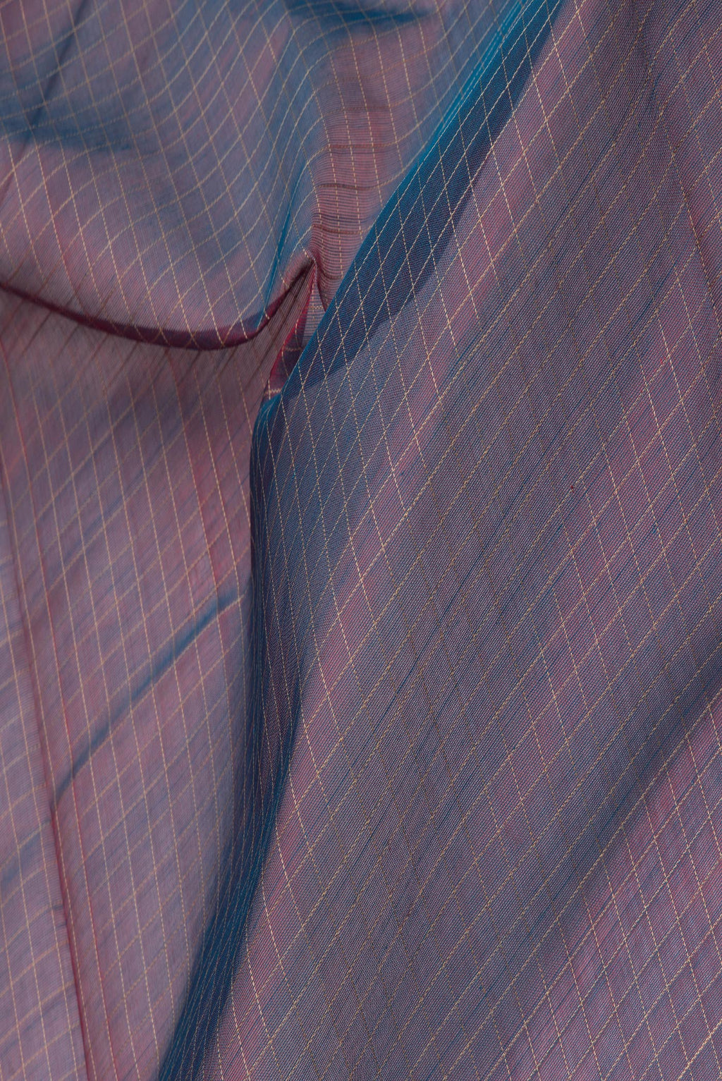 Close up of Purple Dual Tone Silk Cotton Saree with Checked design on the body and Zari And Thread Border.  displaying folds