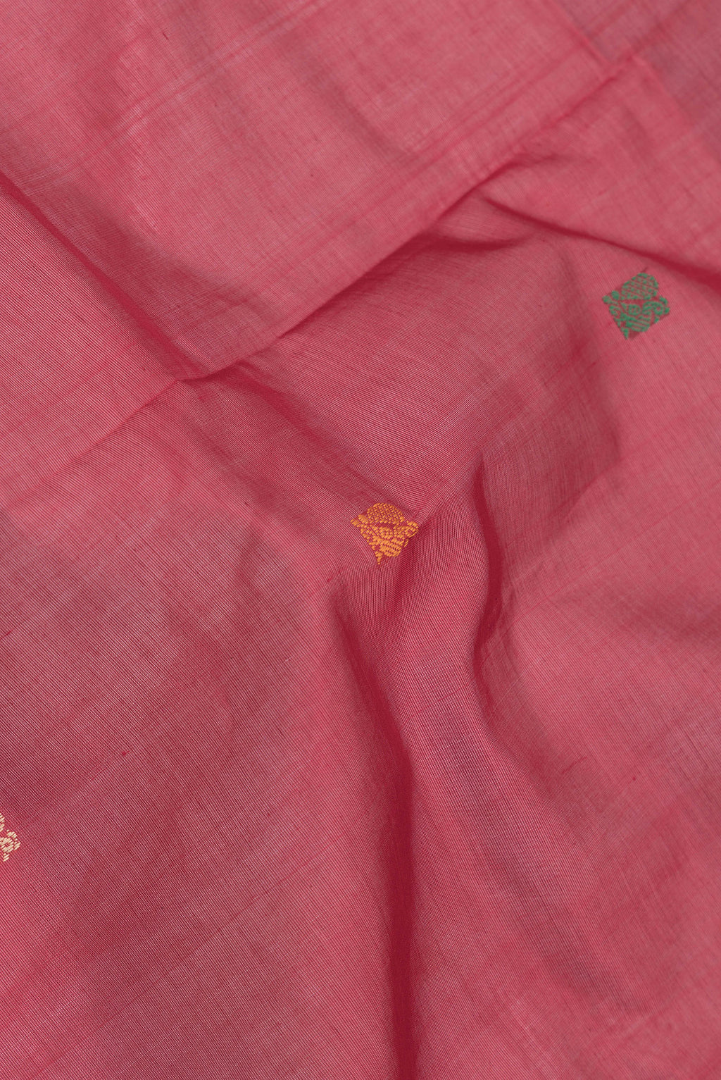 Close up of Red Dual Tone Silk Cotton Saree with Thread Butta on the body and Thread Border.  displaying folds