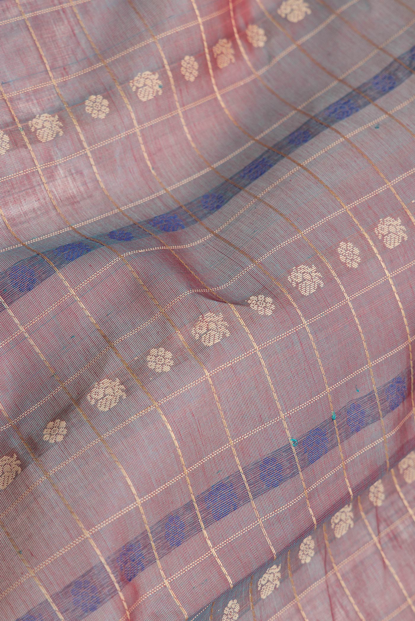 Close up of Peacock Blue Dual Tone Silk Cotton Saree with Thread Butta on the body and Zari Border.  displaying folds