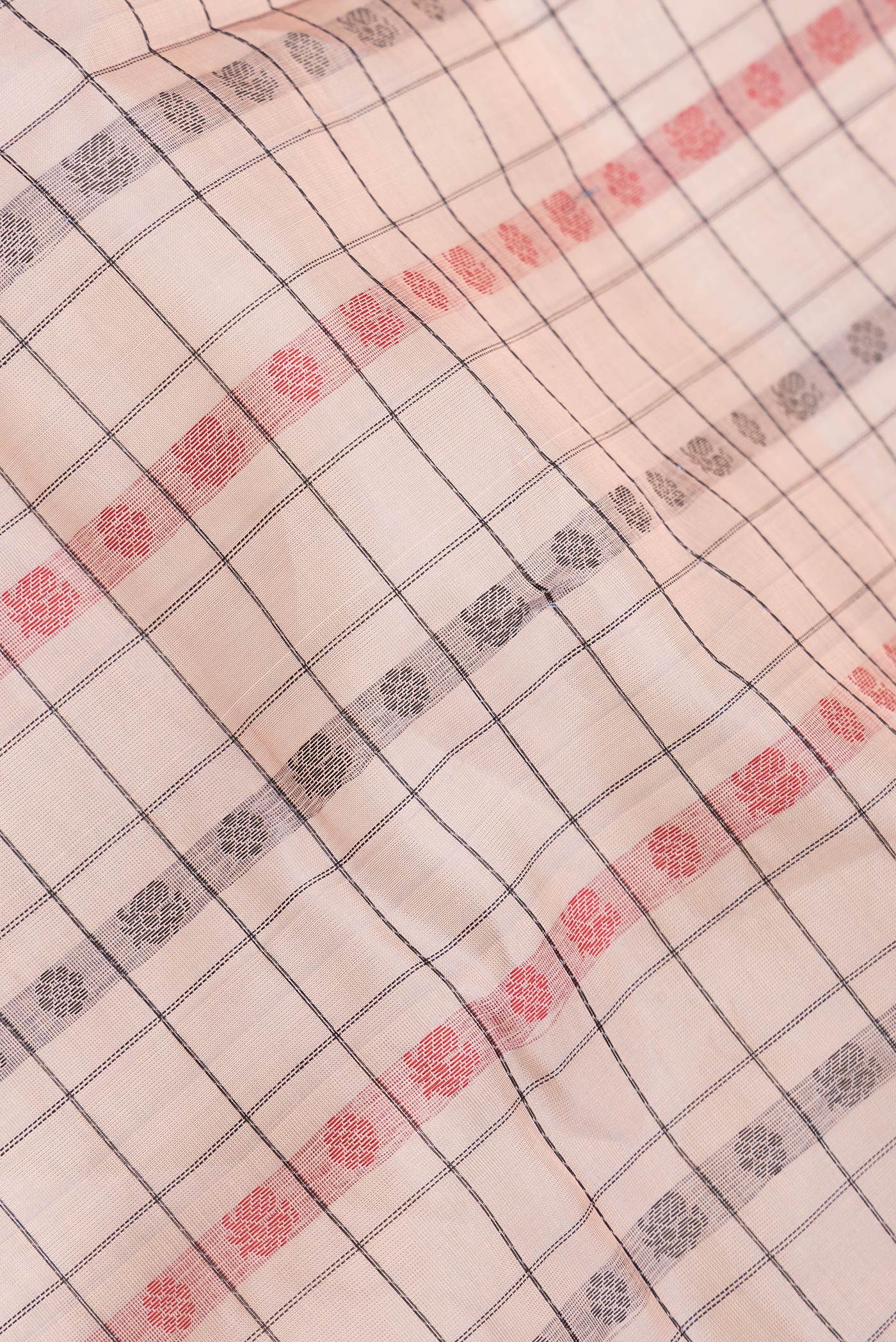 Close up of Golden Peach Dual Tone Silk Cotton Saree with Thread Butta on the body and Zari Border.  displaying folds
