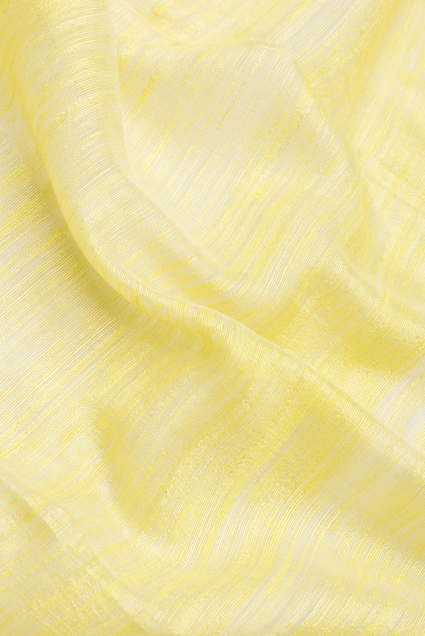 Close up of Yellow Dual Tone Tussar Silk Saree with Plain Body and Fancy Border.  displaying folds