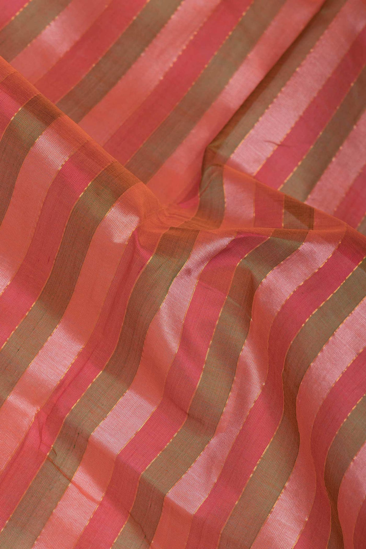 Close up of Red and Green Color Silk Cotton Saree with Stripes on the body and Zari Border.  displaying folds