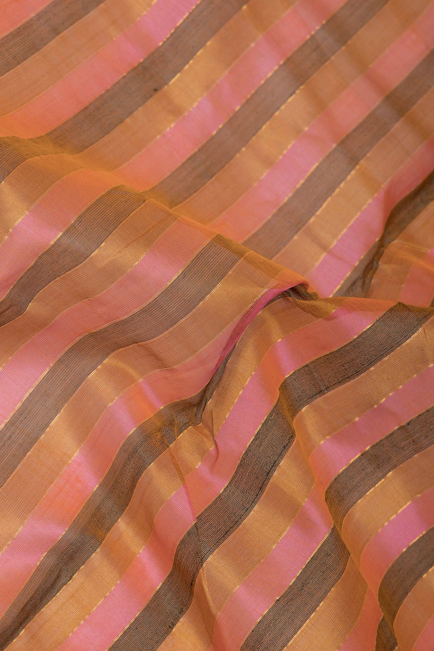 Close up of Pink and Mustard Color Silk Cotton Saree with Stripes on the body and Zari Border.  displaying folds