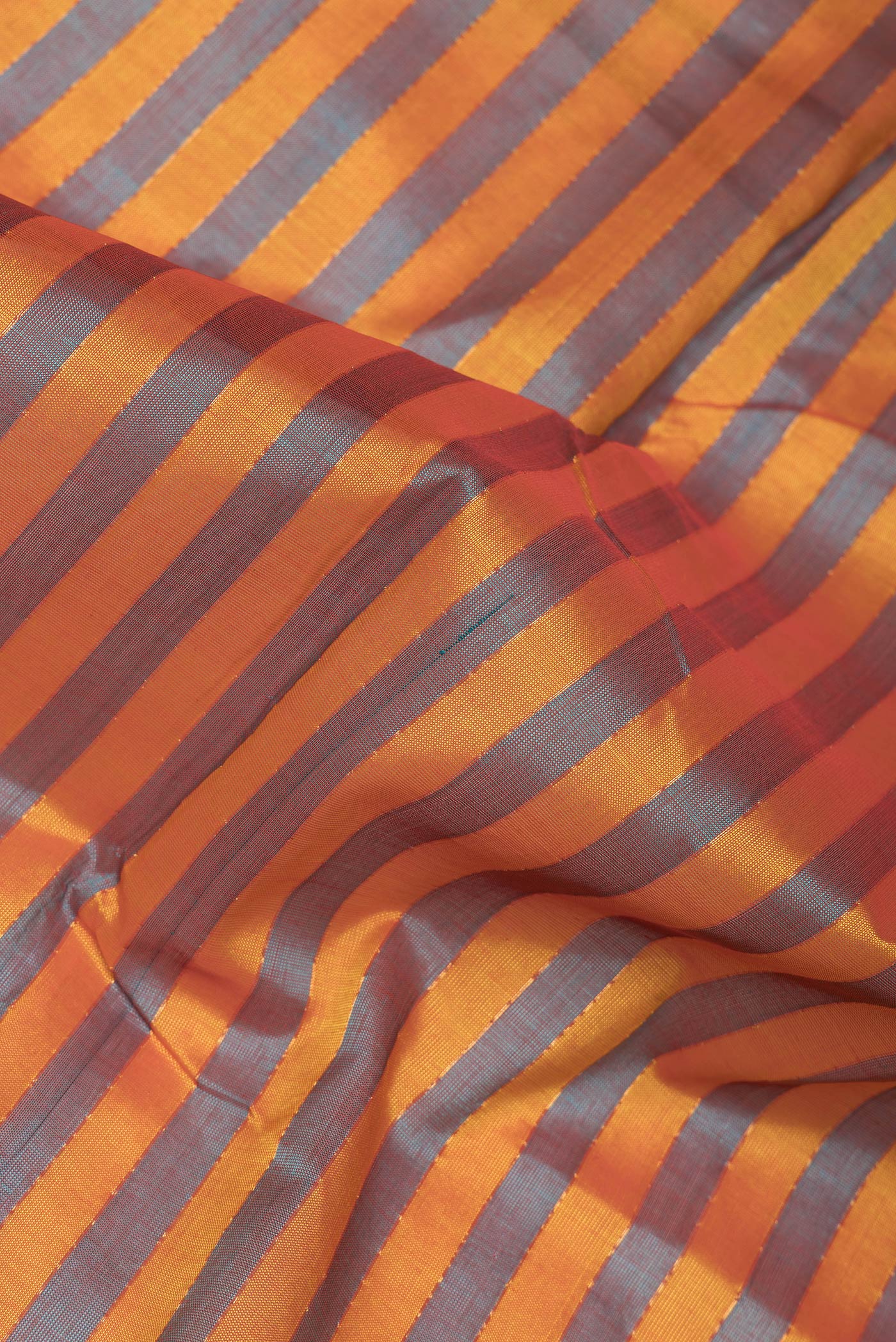 Close up of Yellow and Green Color Silk Cotton Saree with Stripes on the body and Zari Border.  displaying folds