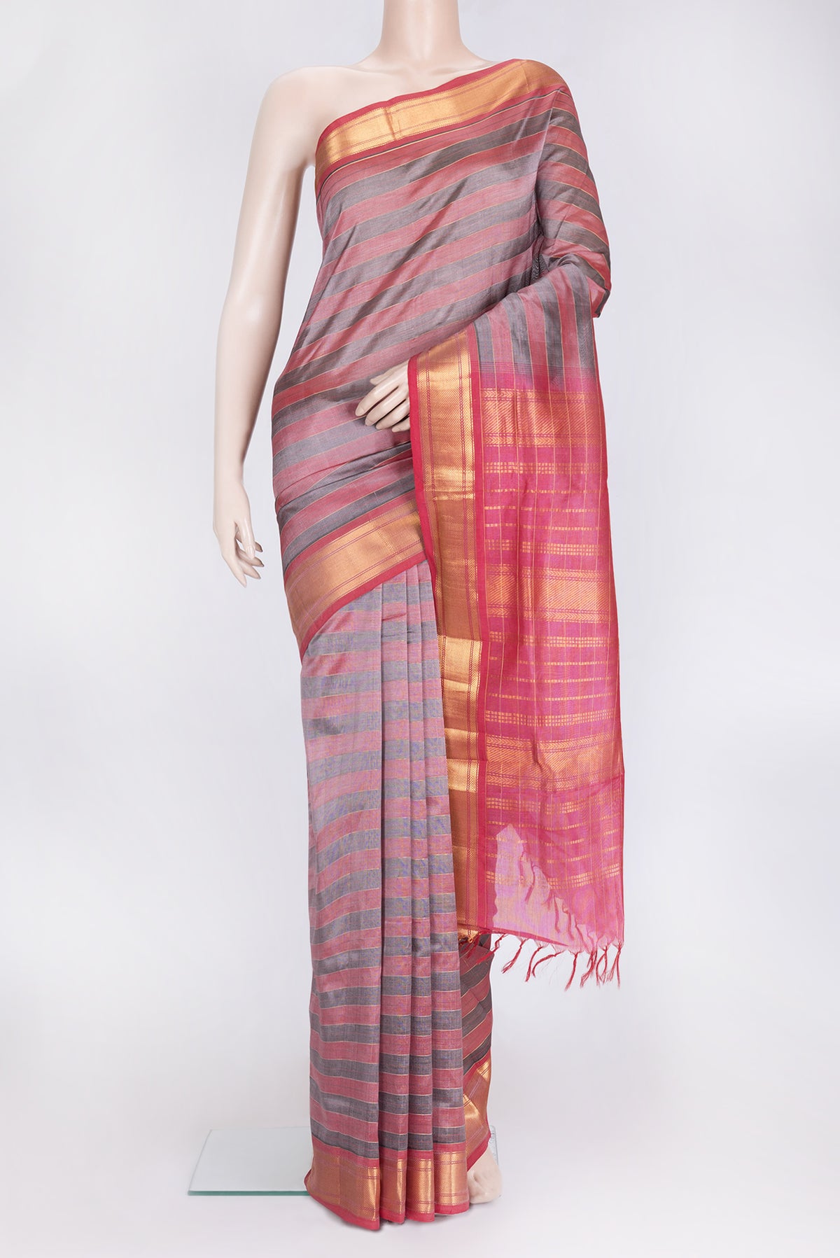 Grey and Pink Color Silk Cotton Saree with Stripes on the body and Zari Border.  displayed on a mannequin