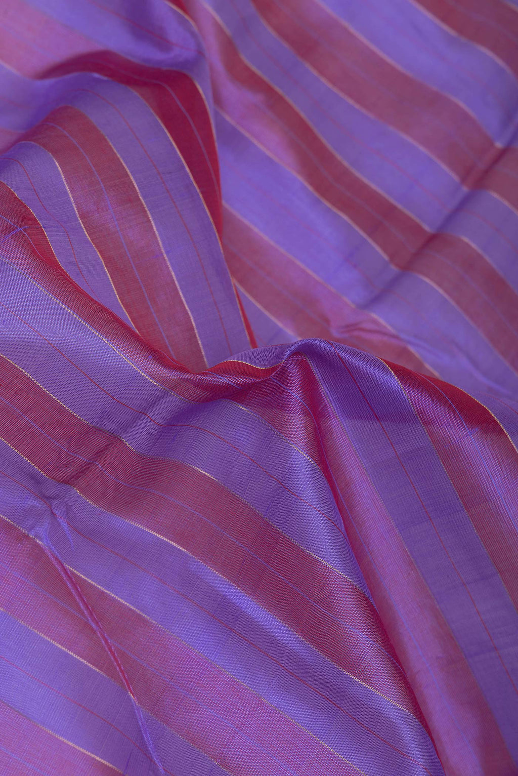 Close up of Lavender and Maroon Color Silk Cotton Saree with Stripes on the body and Zari Border.  displaying folds
