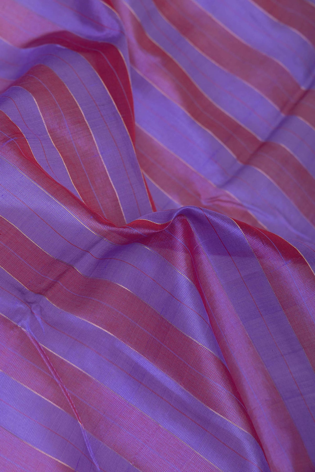 Close up of Lavender and Maroon Color Silk Cotton Saree with Stripes on the body and Zari Border.  displaying folds