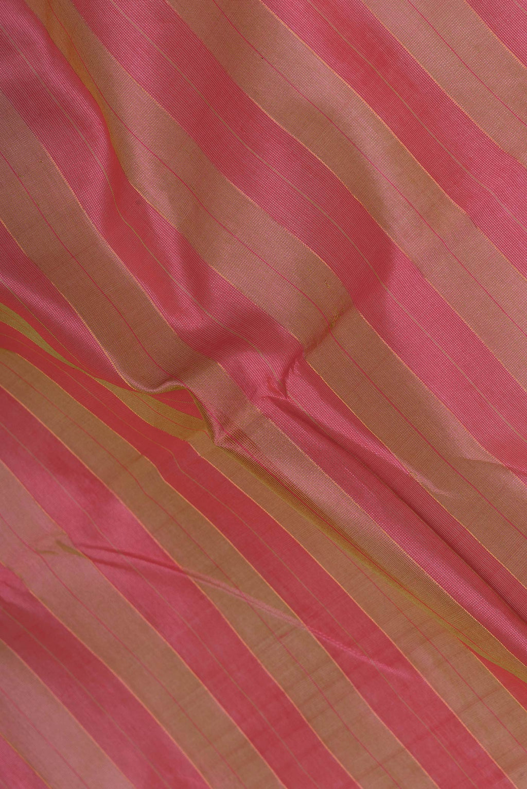Close up of Pink and Green Color Silk Cotton Saree with Stripes on the body and Zari Border.  displaying folds