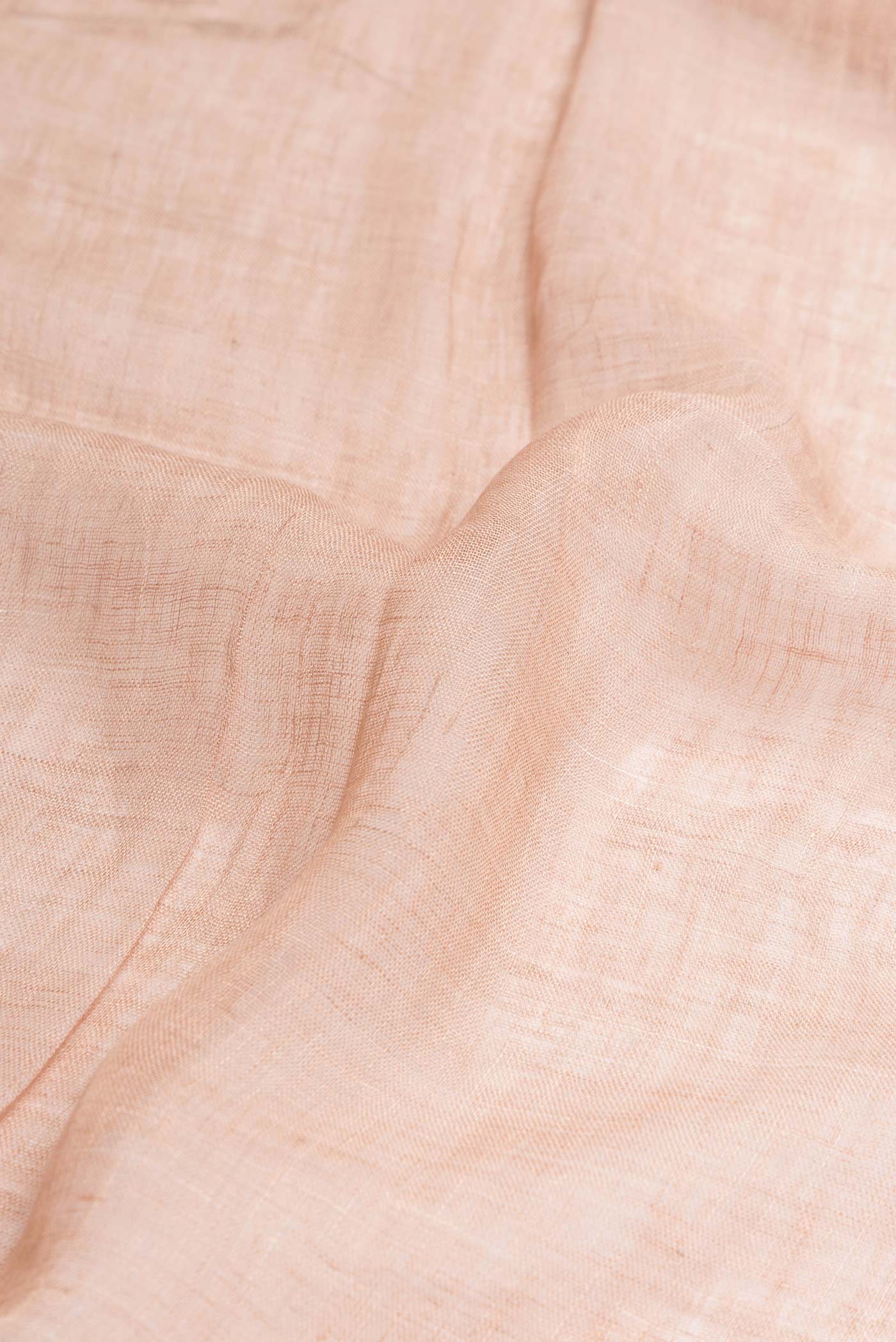 Close up of Peach Dual Tone Linen Saree with Embroidery on the body and Embroidery Border.  displaying folds