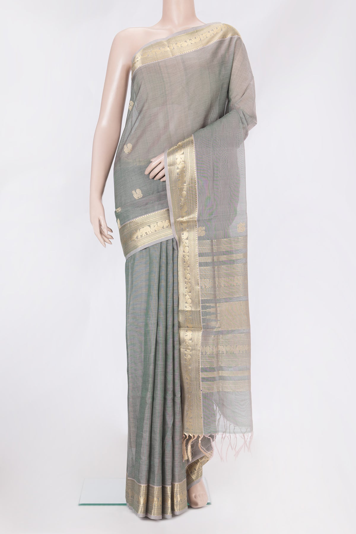 Grey with Green Color Silk Cotton Saree with Zari Butta on the body and Zari Border.  displayed on a mannequin
