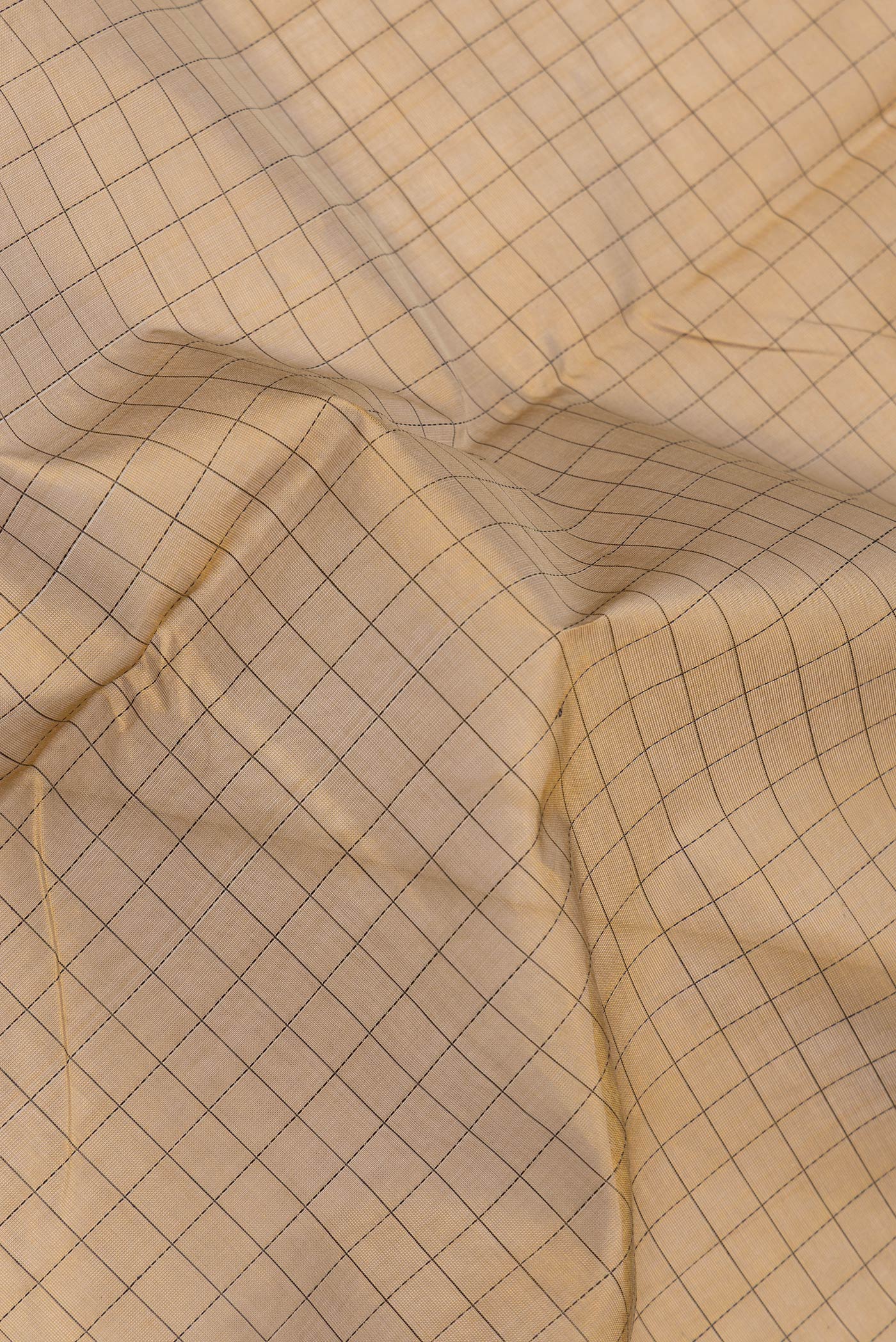 Close up of Gold Dual Tone Silk Cotton Saree with Thread Butta on the body and Fancy Border.  displaying folds