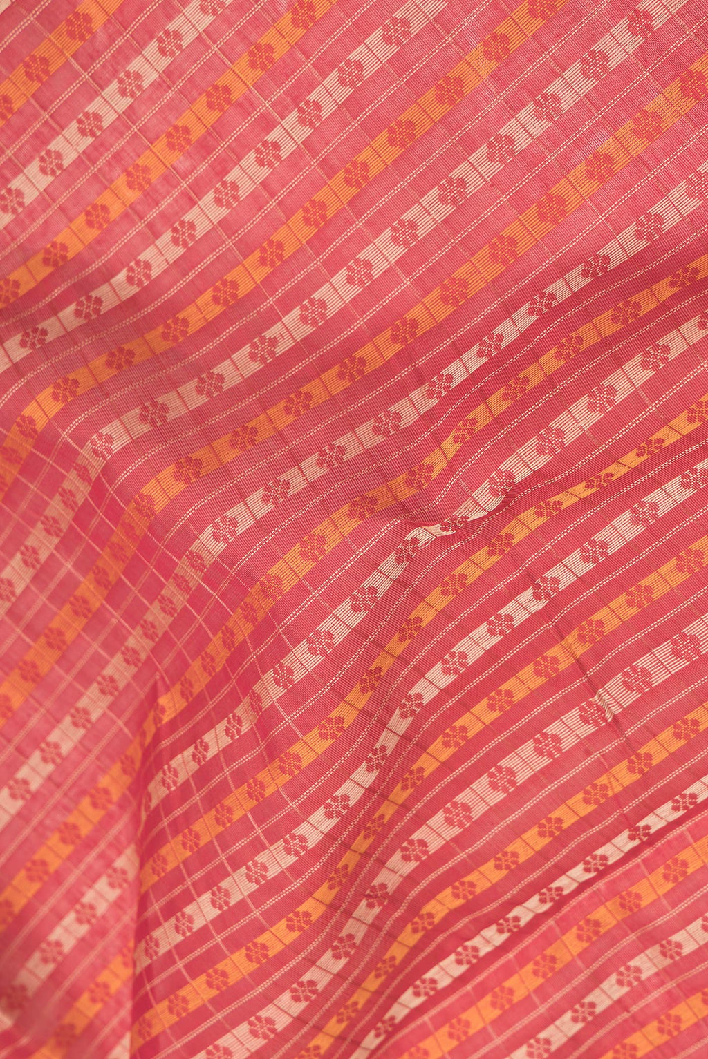 Close up of Red Dual Tone Silk Cotton Saree with Thread Butta on the body and Zari Border.  displaying folds