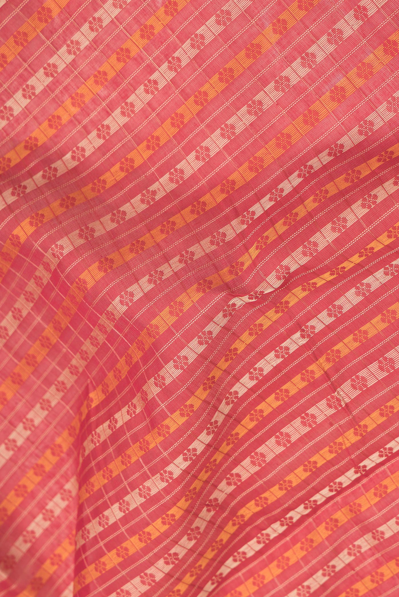 Close up of Red Dual Tone Silk Cotton Saree with Thread Butta on the body and Zari Border.  displaying folds