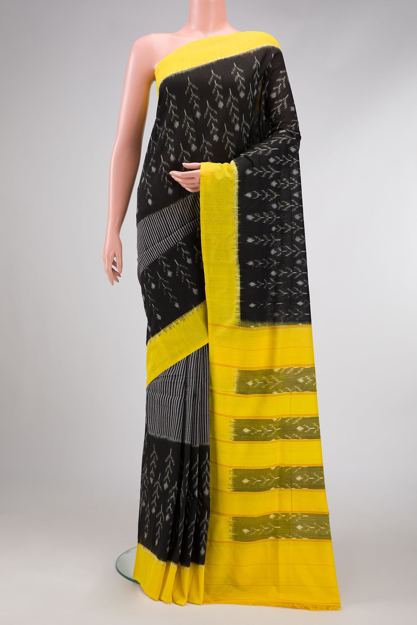 Black Dual Tone Double Ikat Saree with Ikat Print on the body and Plain Border.  displayed on a mannequin