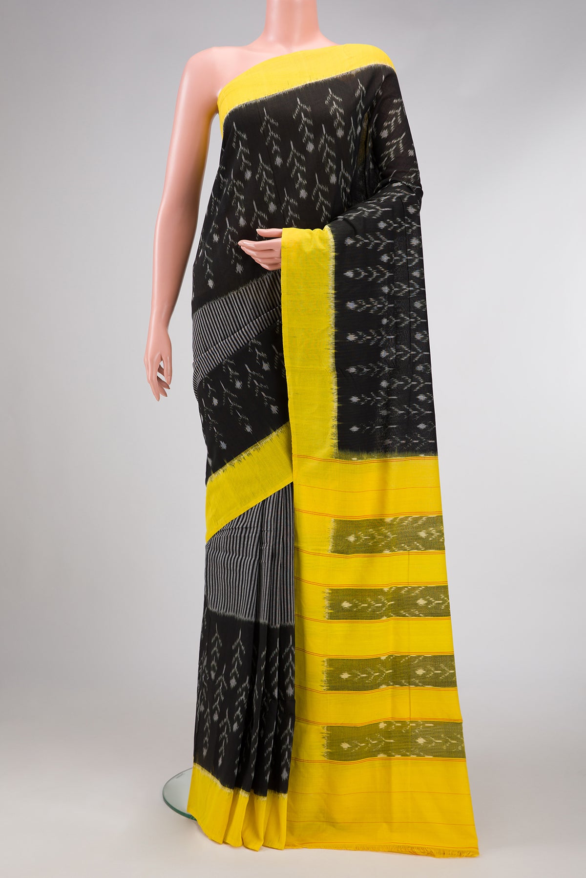 Black Dual Tone Double Ikat Saree with Ikat Print on the body and Plain Border.  displayed on a mannequin