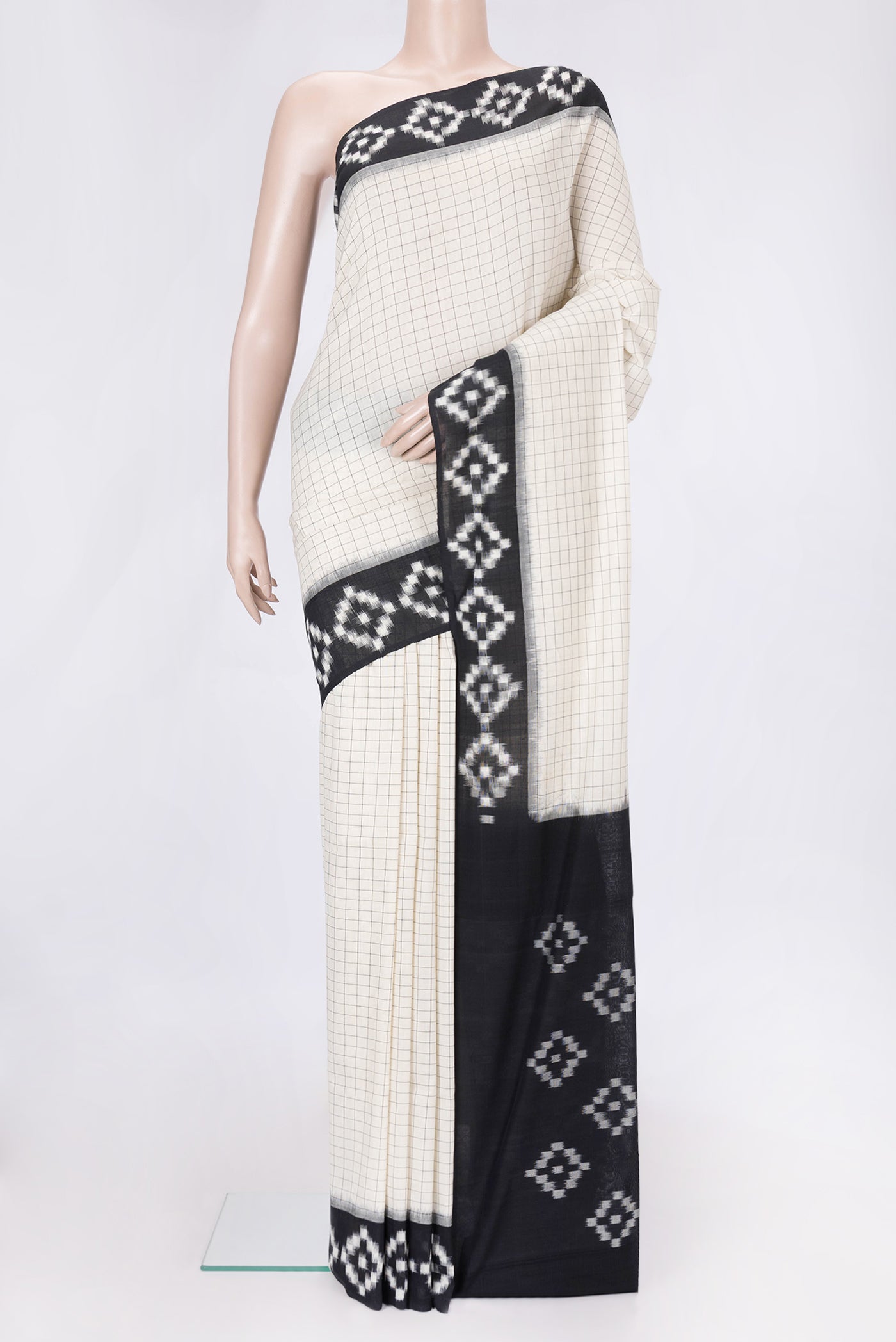Off White Dual Tone Double Ikat Saree with Checked design on the body and Ikat Border.  displayed on a mannequin