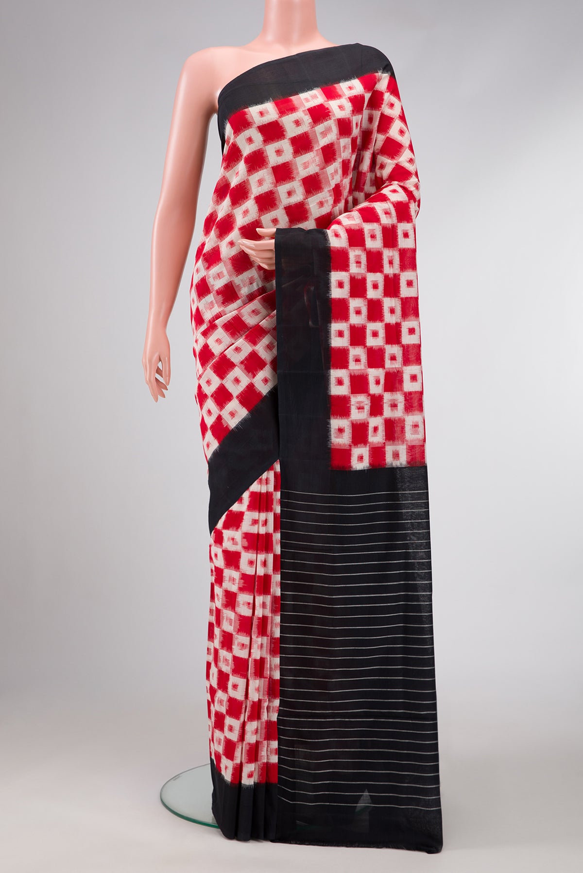 Red Dual Tone Double Ikat Saree with Ikat Print on the body and Plain Border.  displayed on a mannequin
