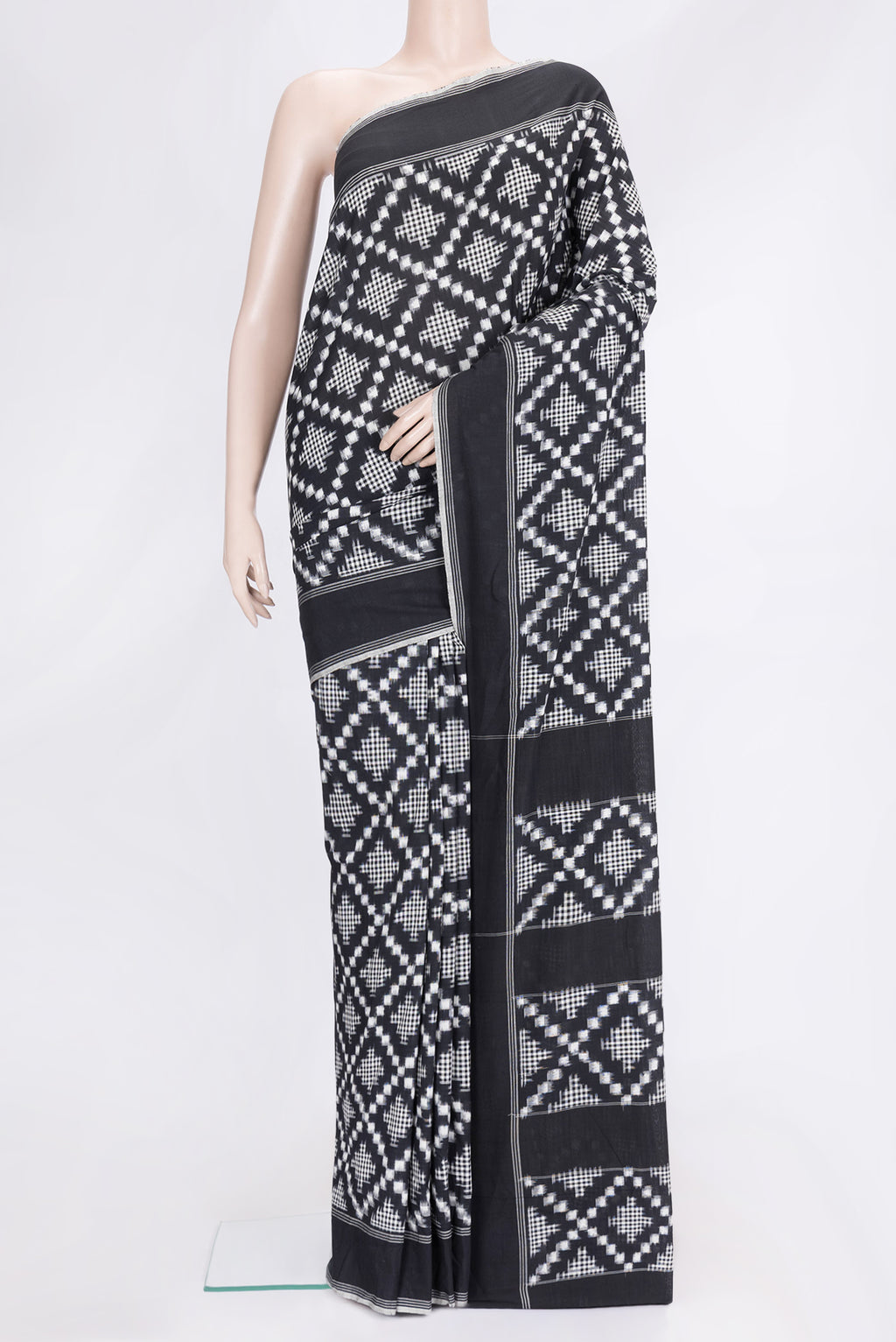 Black Dual Tone Double Ikat Saree with Ikat Print on the body and Plain Border.  displayed on a mannequin