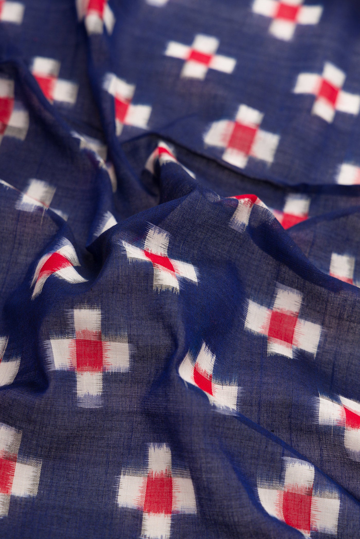 Close up of Navy Blue Dual Tone Double Ikat Saree with Ikat Print on the body and Plain Border.  displaying folds
