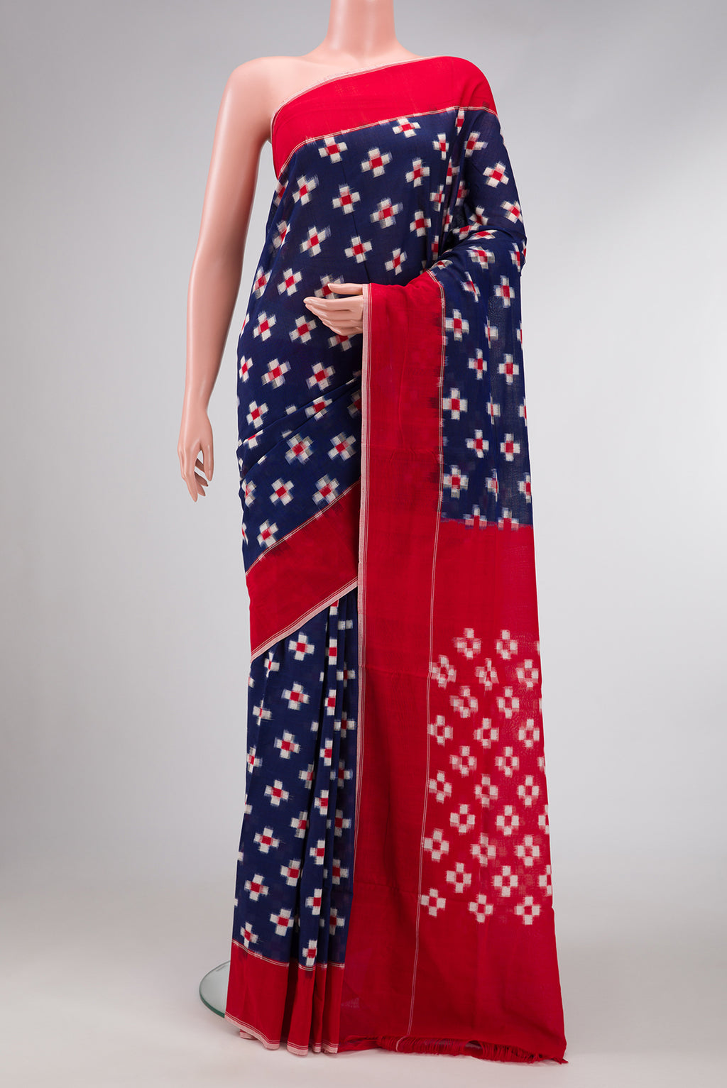 Navy Blue Dual Tone Double Ikat Saree with Ikat Print on the body and Plain Border.  displayed on a mannequin