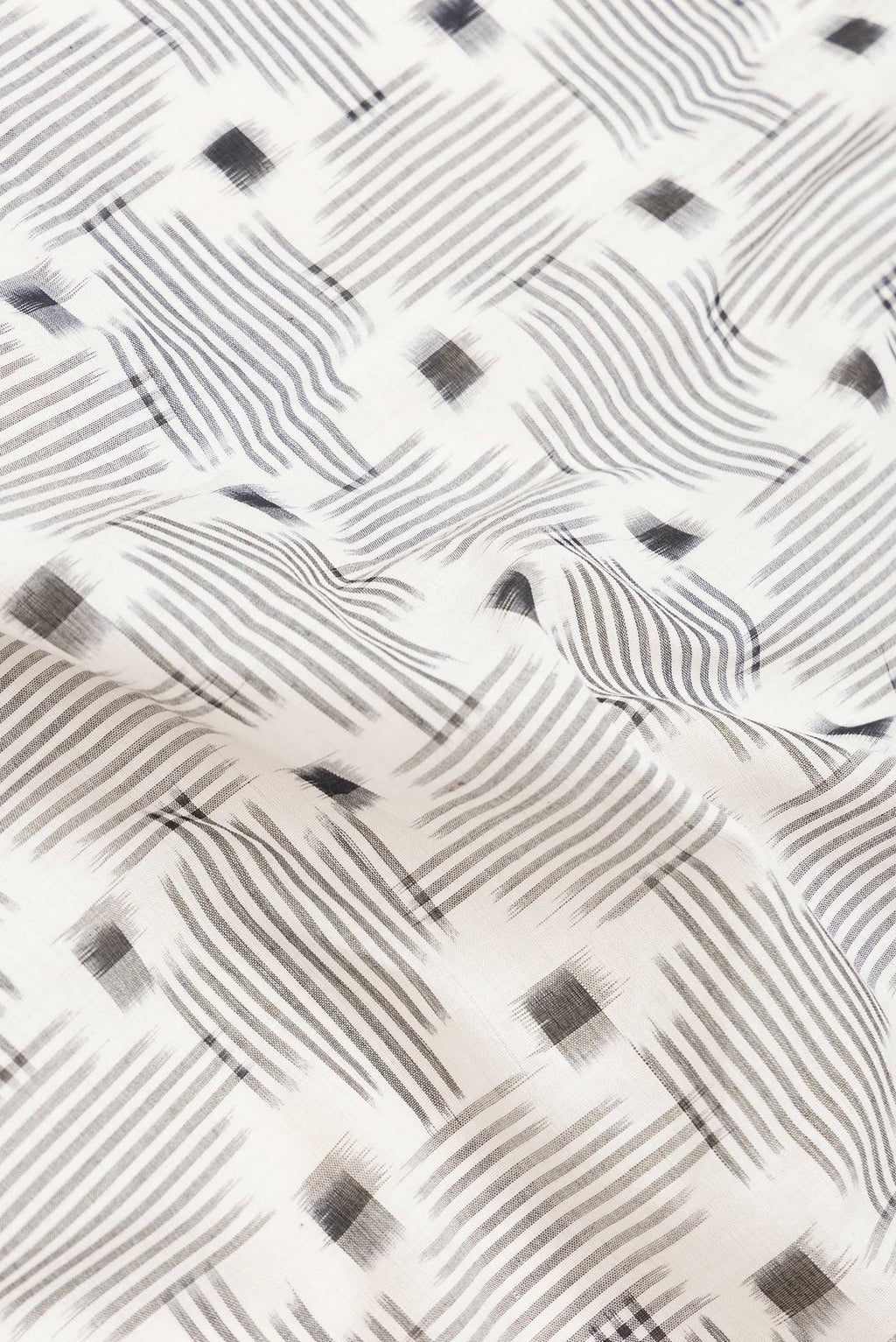 Close up of Off White Dual Tone Double Ikat Saree with Ikat Print on the body and Thread Border.  displaying folds