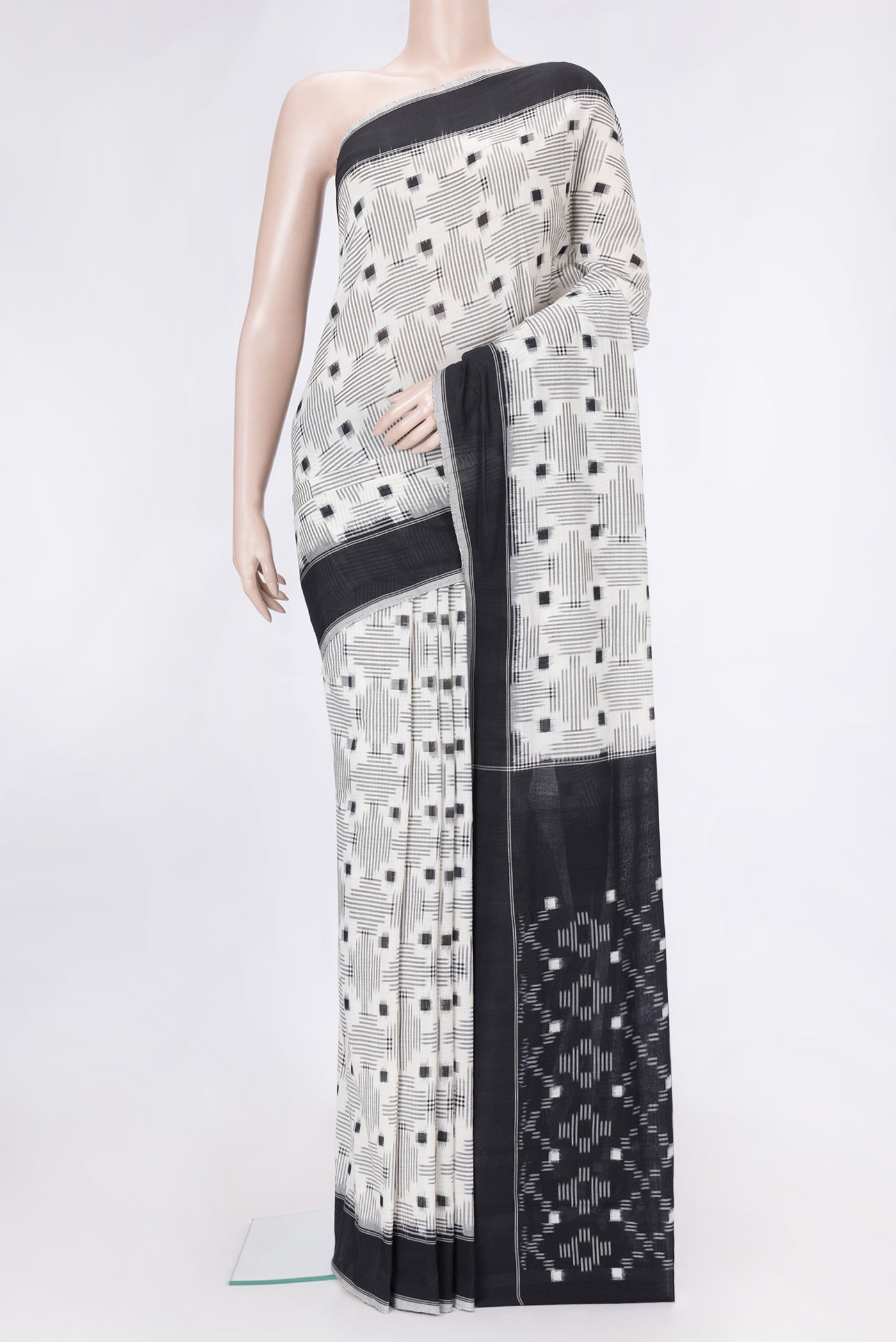 Off White Dual Tone Double Ikat Saree with Ikat Print on the body and Thread Border.  displayed on a mannequin