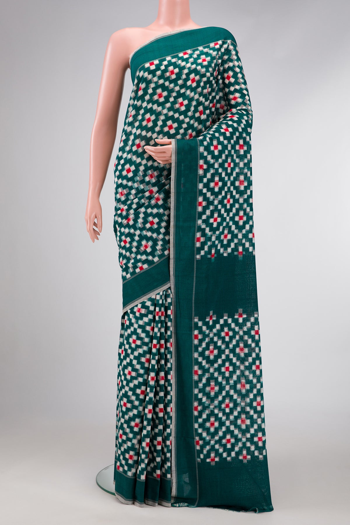 Bottle Green Dual Tone Double Ikat Saree with Ikat Print on the body and Plain Border.  displayed on a mannequin