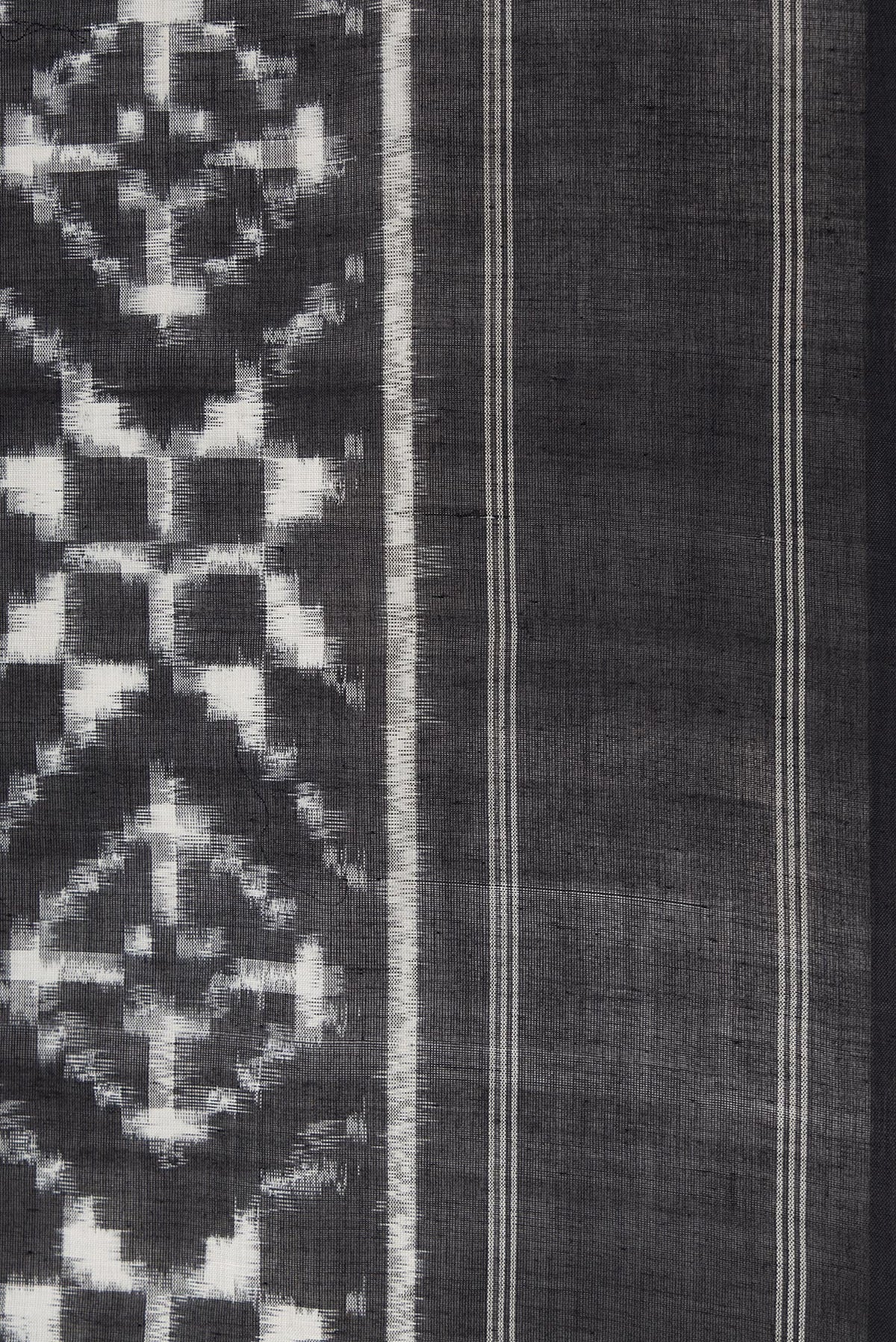 Border image of Black Dual Tone Double Ikat Saree with Ikat Print on the body and Plain Border. 