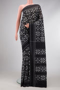 Black Dual Tone Double Ikat Saree with Ikat Print on the body and Plain Border.  displayed on a mannequin