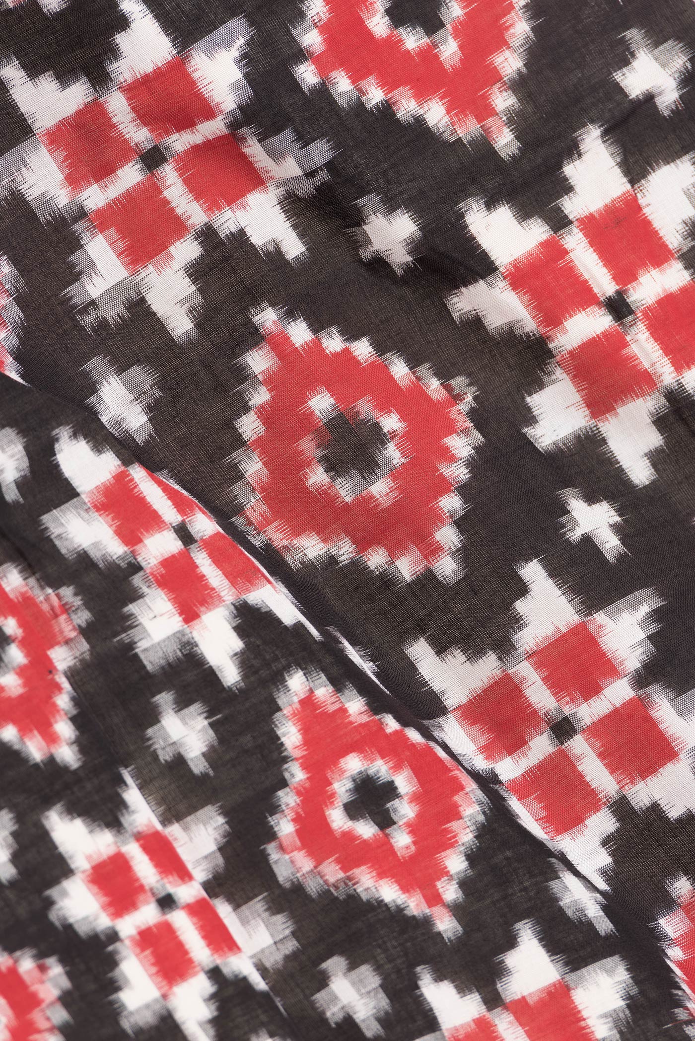 Close up of Black Dual Tone Double Ikat Saree with Ikat Print on the body and Thread Border.  displaying folds