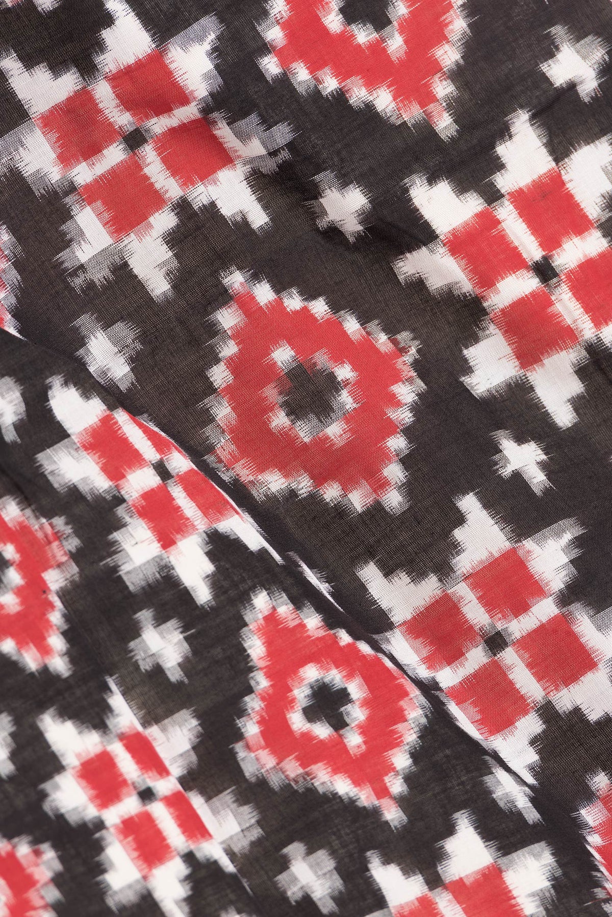 Close up of Black Dual Tone Double Ikat Saree with Ikat Print on the body and Thread Border.  displaying folds