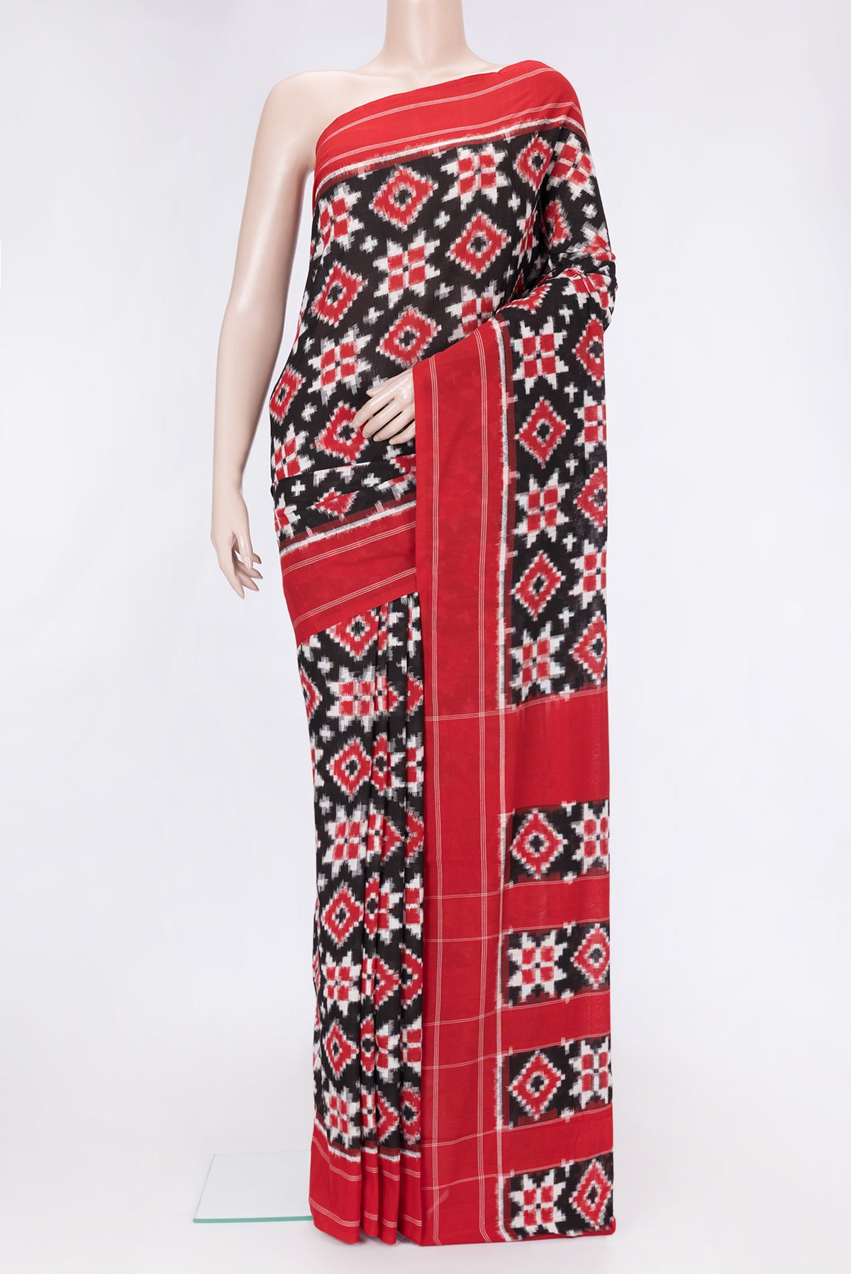 Black Dual Tone Double Ikat Saree with Ikat Print on the body and Thread Border.  displayed on a mannequin