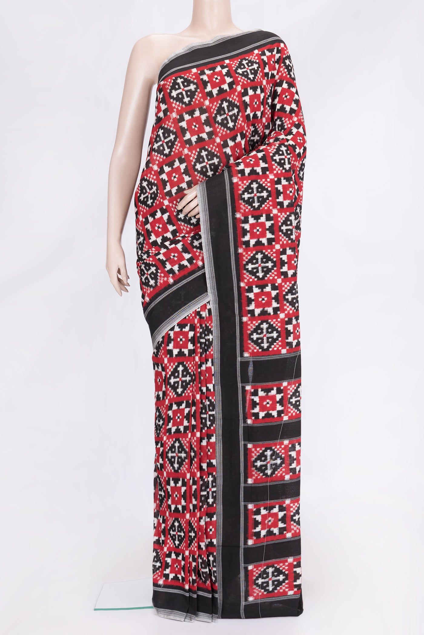 Black and Red Color Double Ikat Saree with Ikat Print on the body and Plain Border.  displayed on a mannequin
