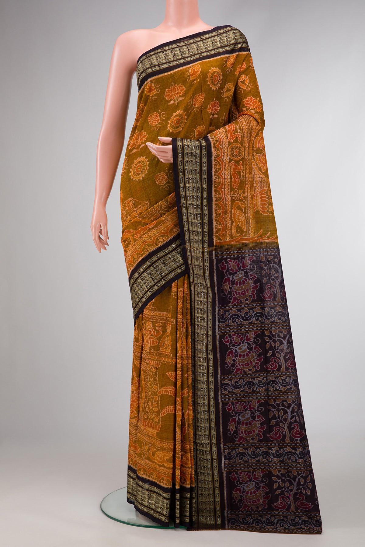 Mustard Dual Tone Double Ikat Saree with Ikat Print on the body and Thread Border.  displayed on a mannequin