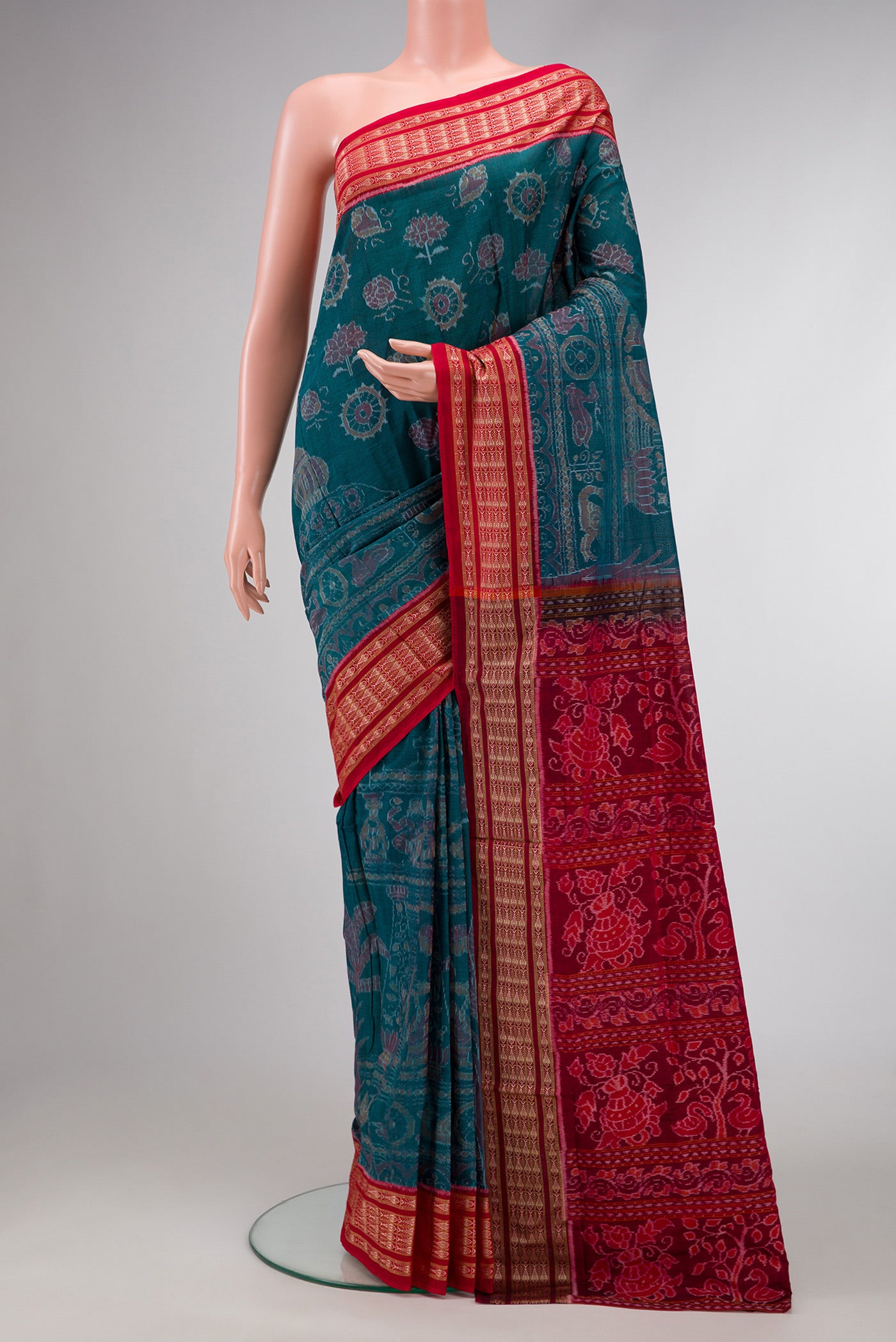 Peacock Blue Dual Tone Double Ikat Saree with Ikat Print on the body and Thread Border.  displayed on a mannequin