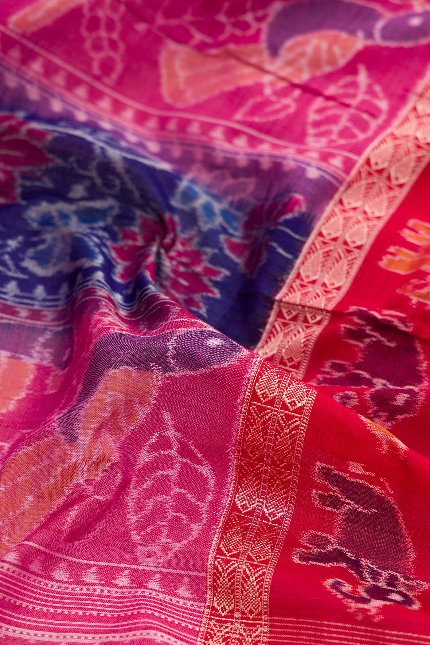 Close up of Royal Blue Dual Tone Double Ikat Saree with Ikat Print on the body and Thread Border.  displaying folds