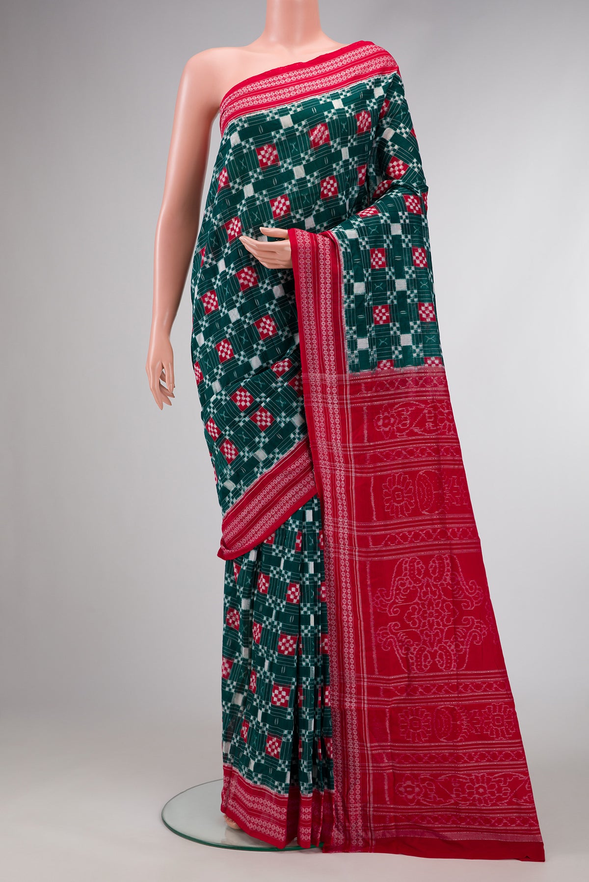 Bottle Green Dual Tone Double Ikat Saree with Ikat Print on the body and Thread Border.  displayed on a mannequin