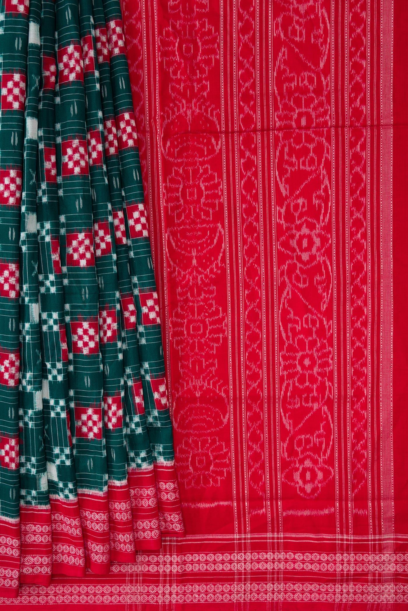 Pleats and pallu of Bottle Green Dual Tone Double Ikat Saree with Ikat Print on the body and Thread Border. 