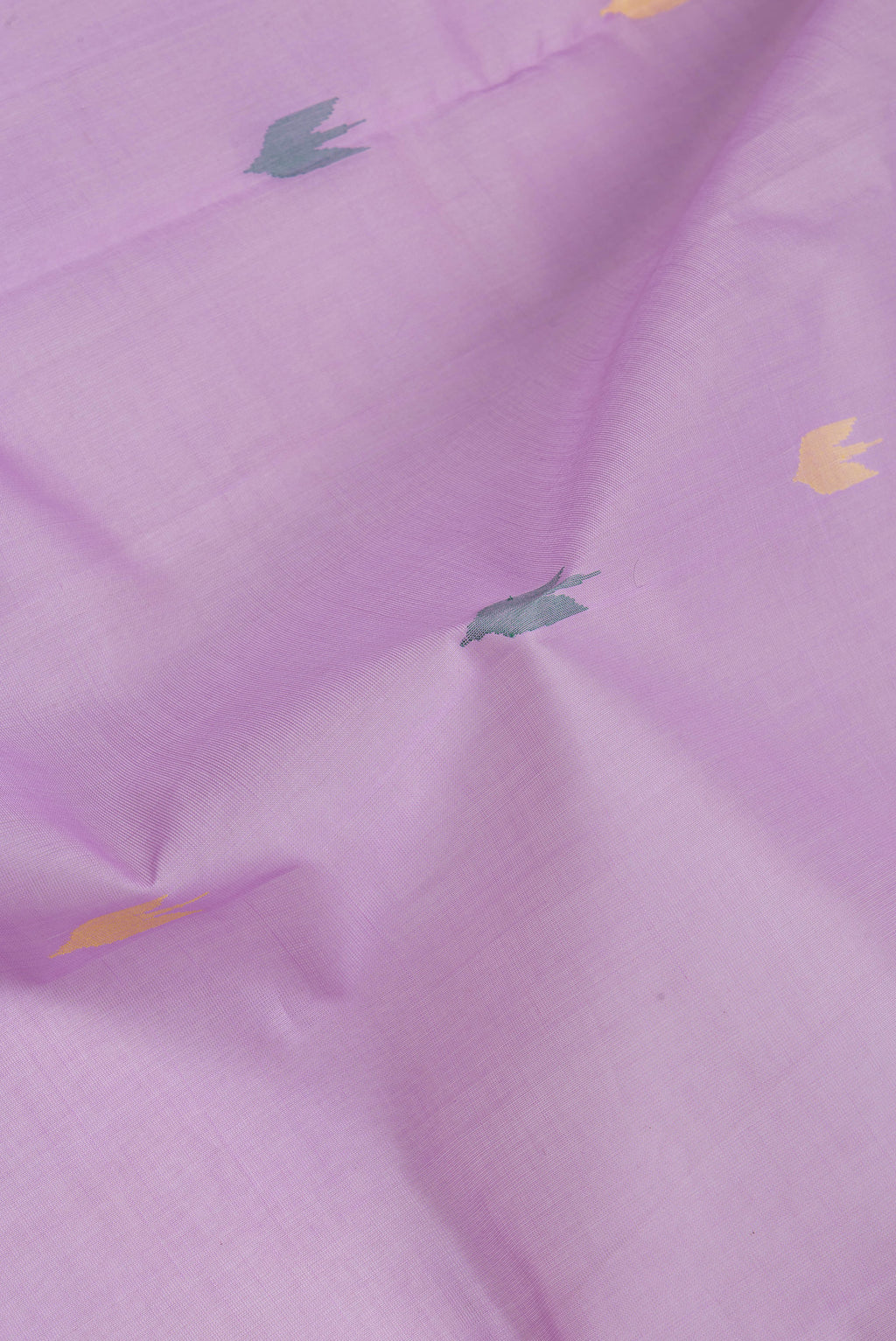 Close up of Lavender Uppada Cotton Saree with Zari And Thread Butta on the body and Zari Border.  displaying folds