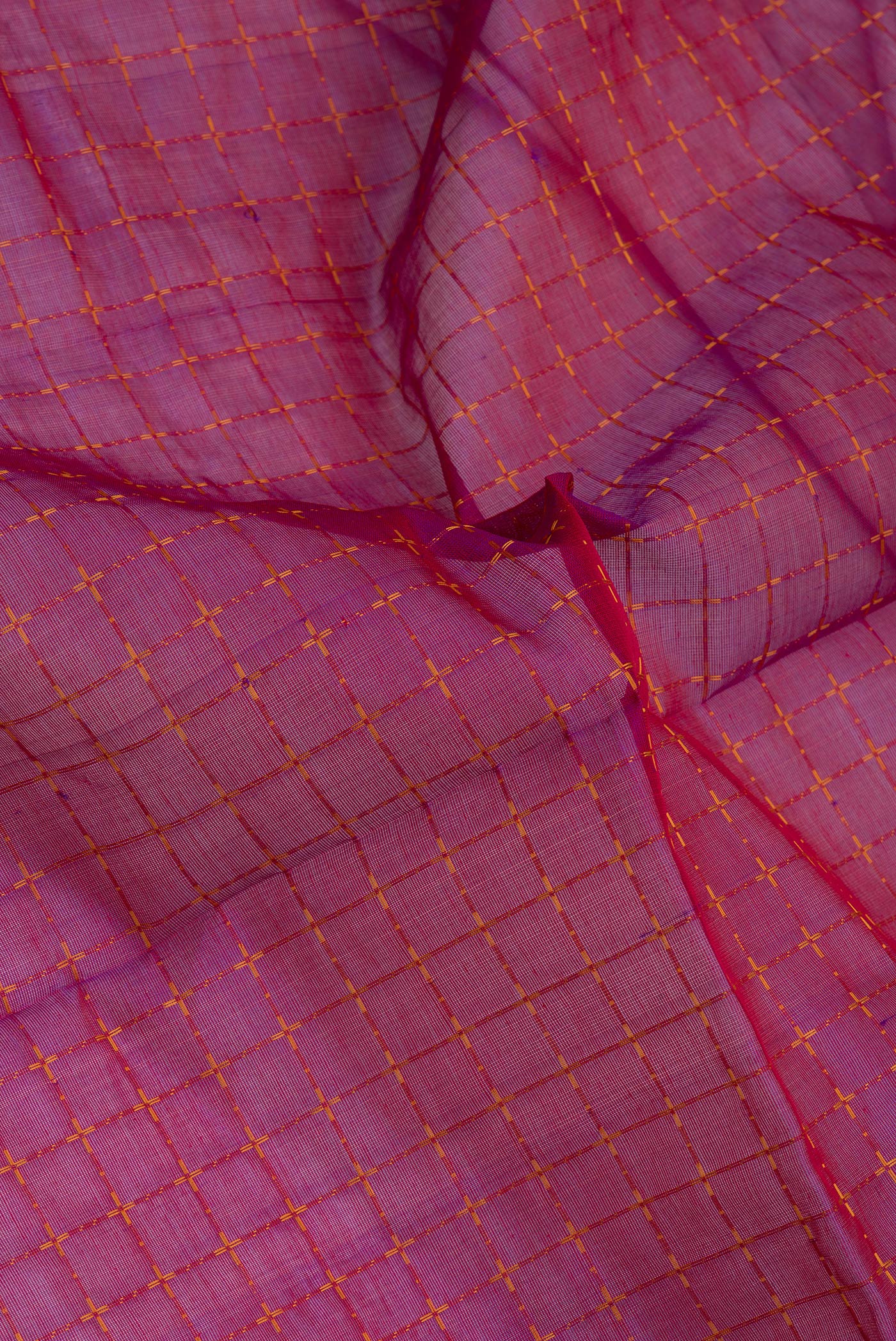 Close up of Purple Silk Cotton Saree with Checked design on the body and Zari Border.  displaying folds