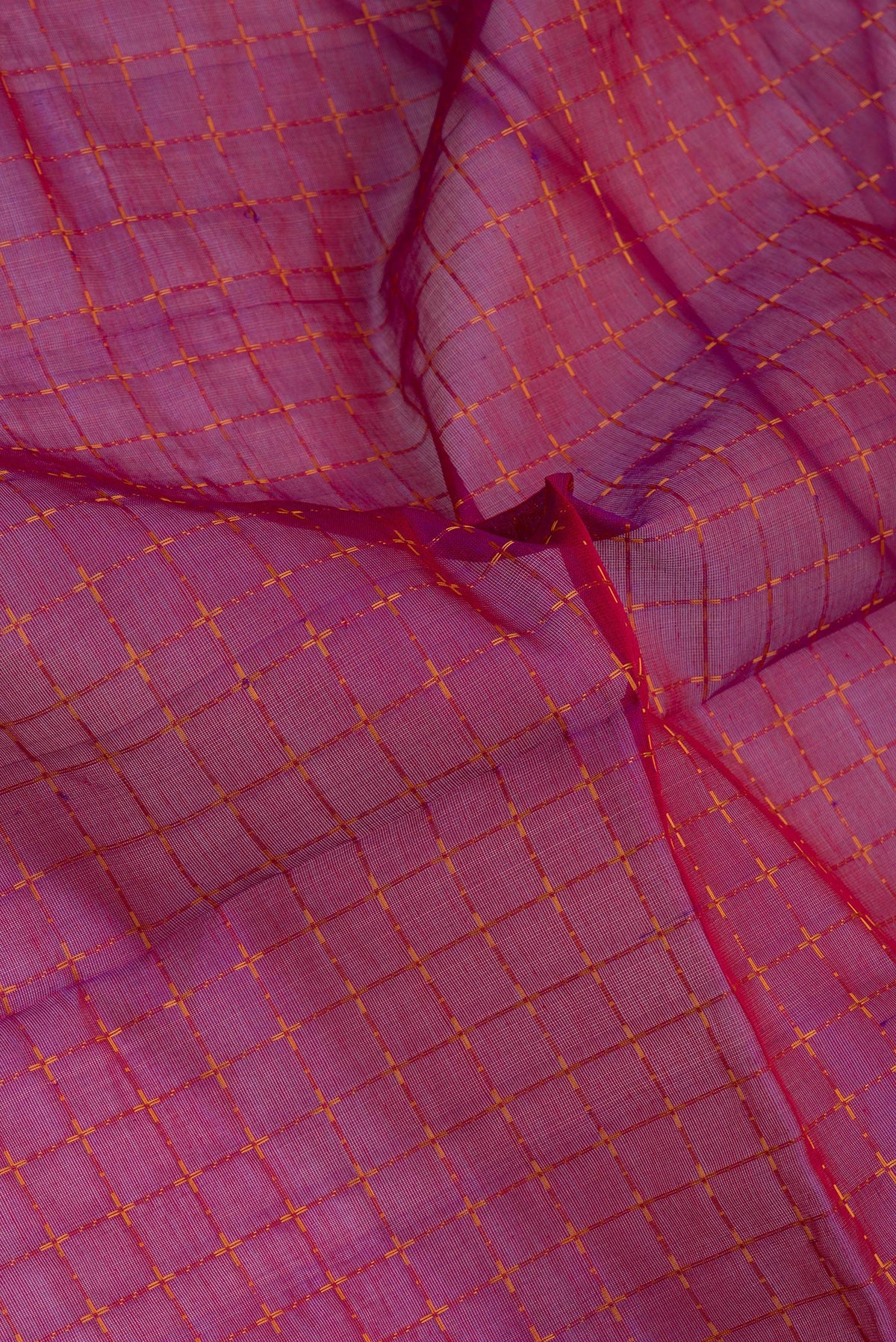 Close up of Purple Silk Cotton Saree with Checked design on the body and Zari Border.  displaying folds