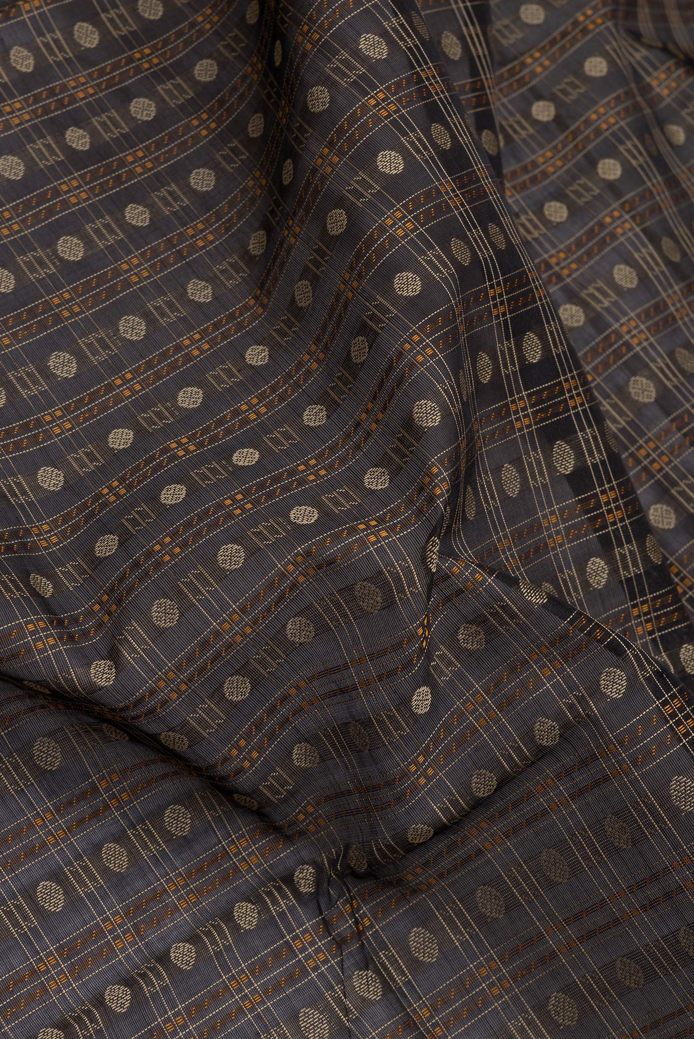 Close up of Black Silk Cotton Saree with Checked design on the body and Zari Border.  displaying folds