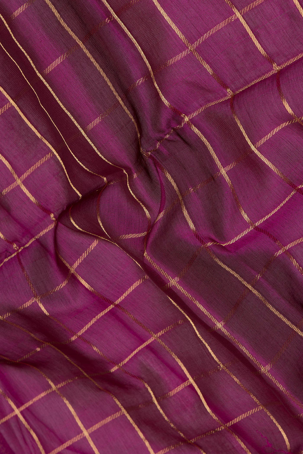 Close up of Magenta Silk Cotton Saree with Checked design on the body and Zari Border.  displaying folds