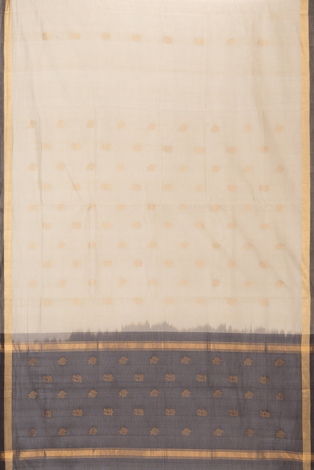 Flat view of Beige Uppada Cotton Saree with Zari Butta on the body and Zari Border. 