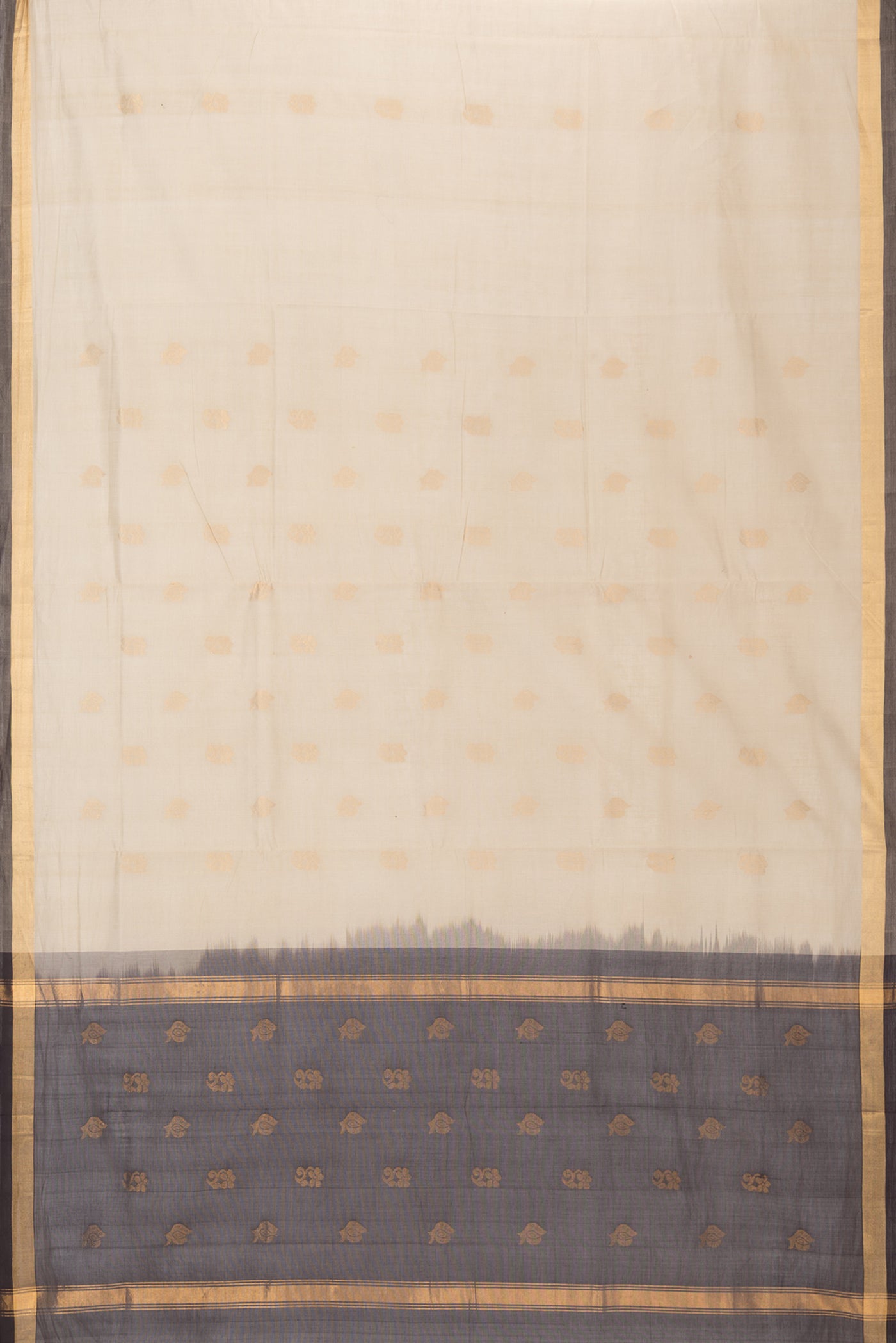 Flat view of Beige Uppada Cotton Saree with Zari Butta on the body and Zari Border. 