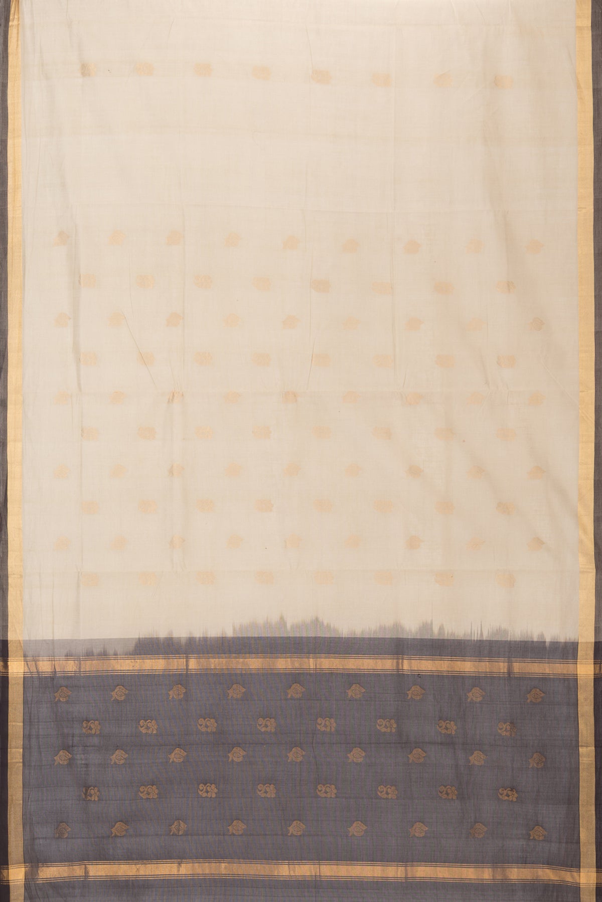 Flat view of Beige Uppada Cotton Saree with Zari Butta on the body and Zari Border. 