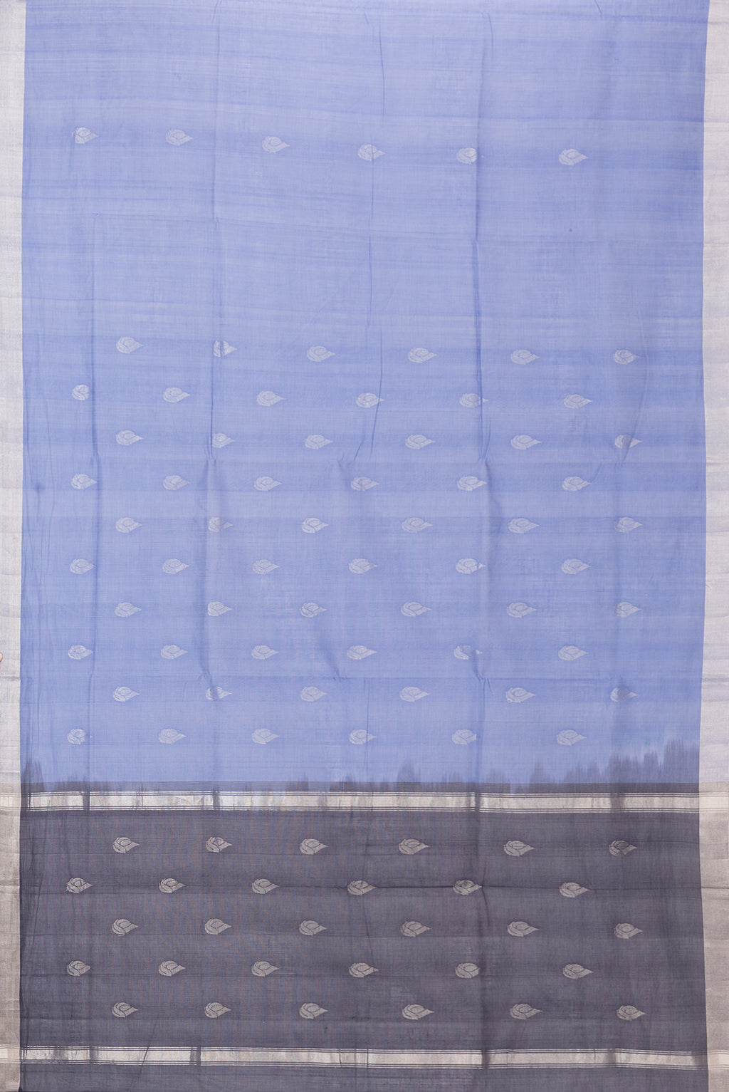 Flat view of Blue Uppada Cotton Saree with Zari Butta on the body and Zari Border. 