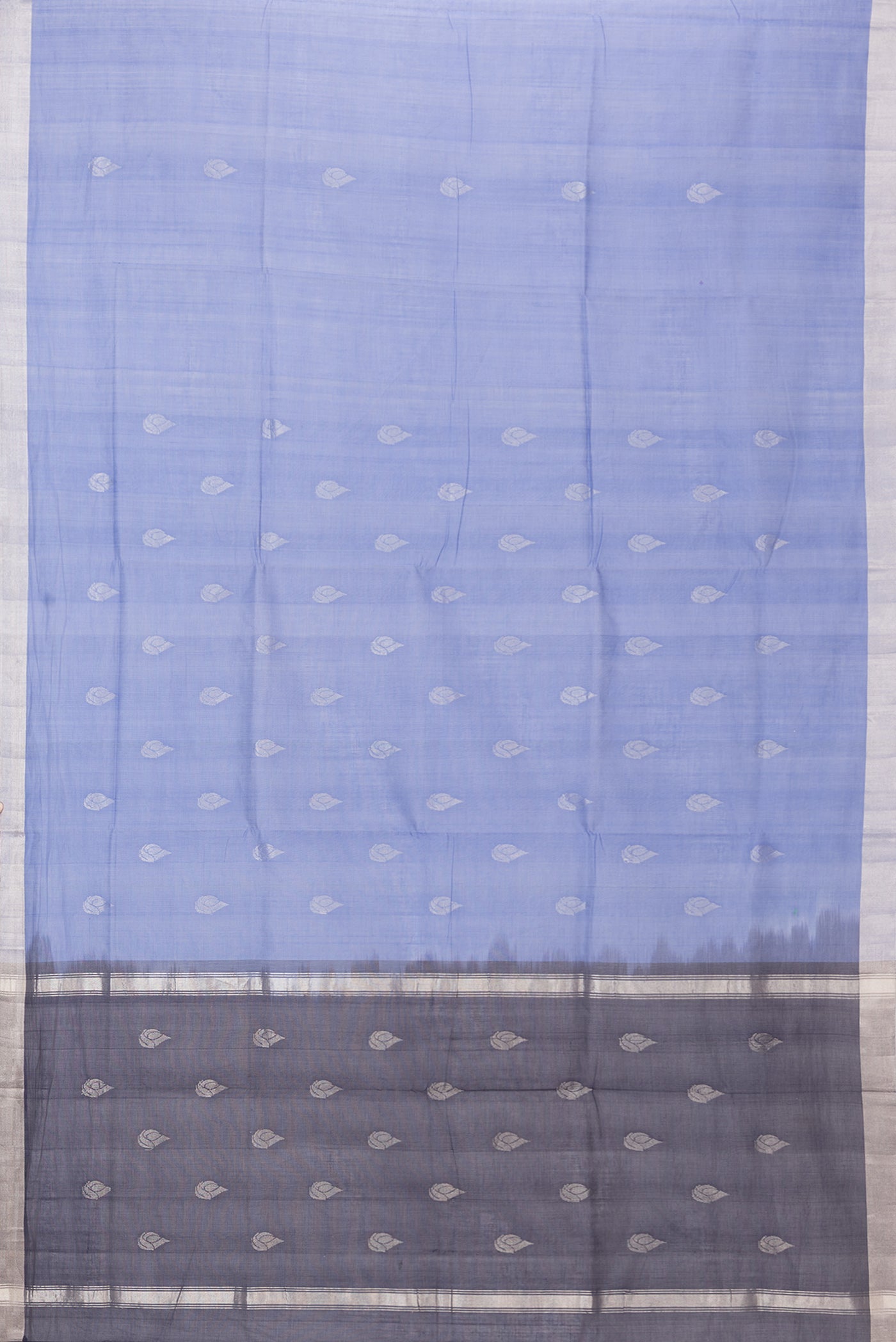 Flat view of Blue Uppada Cotton Saree with Zari Butta on the body and Zari Border. 