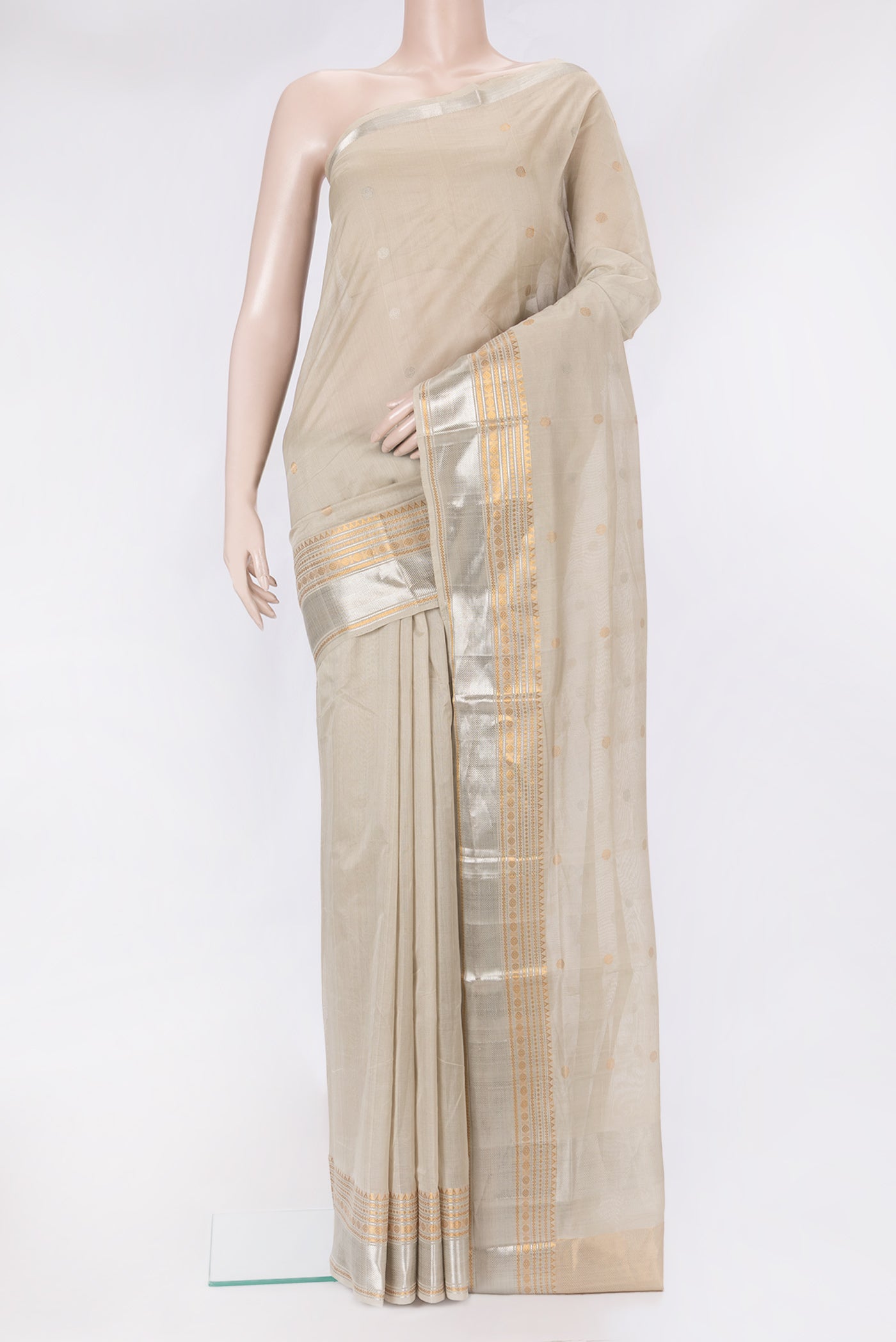 Beige Uppada Cotton Saree with Zari Butta on the body and Zari Border.  displayed on a mannequin