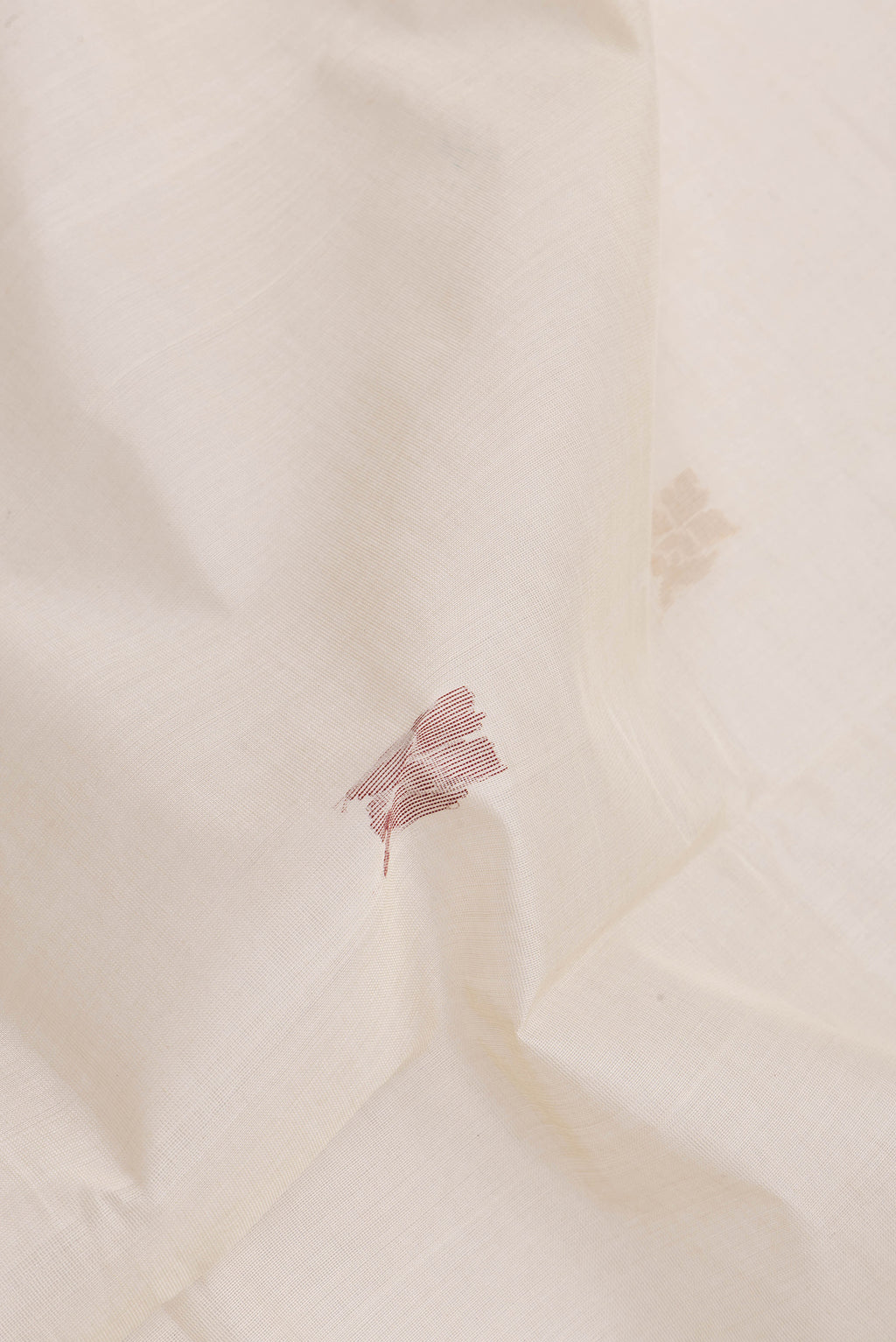 Close up of Beige Uppada Cotton Saree with Zari And Thread Butta on the body and Zari Border.  displaying folds